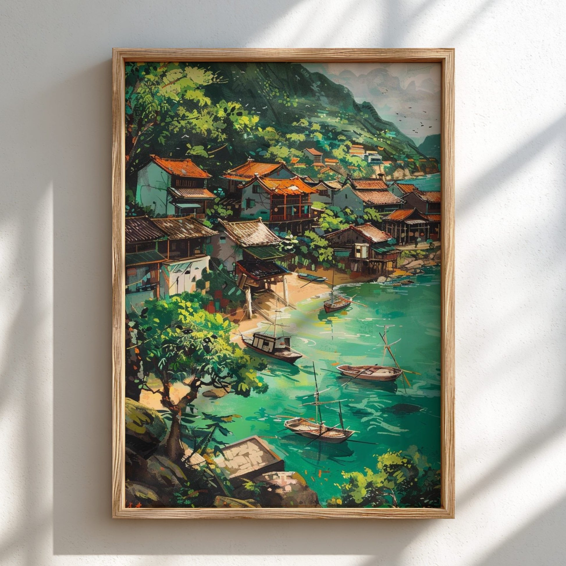 Framed painting of a coastal village scene with boats and greenery.