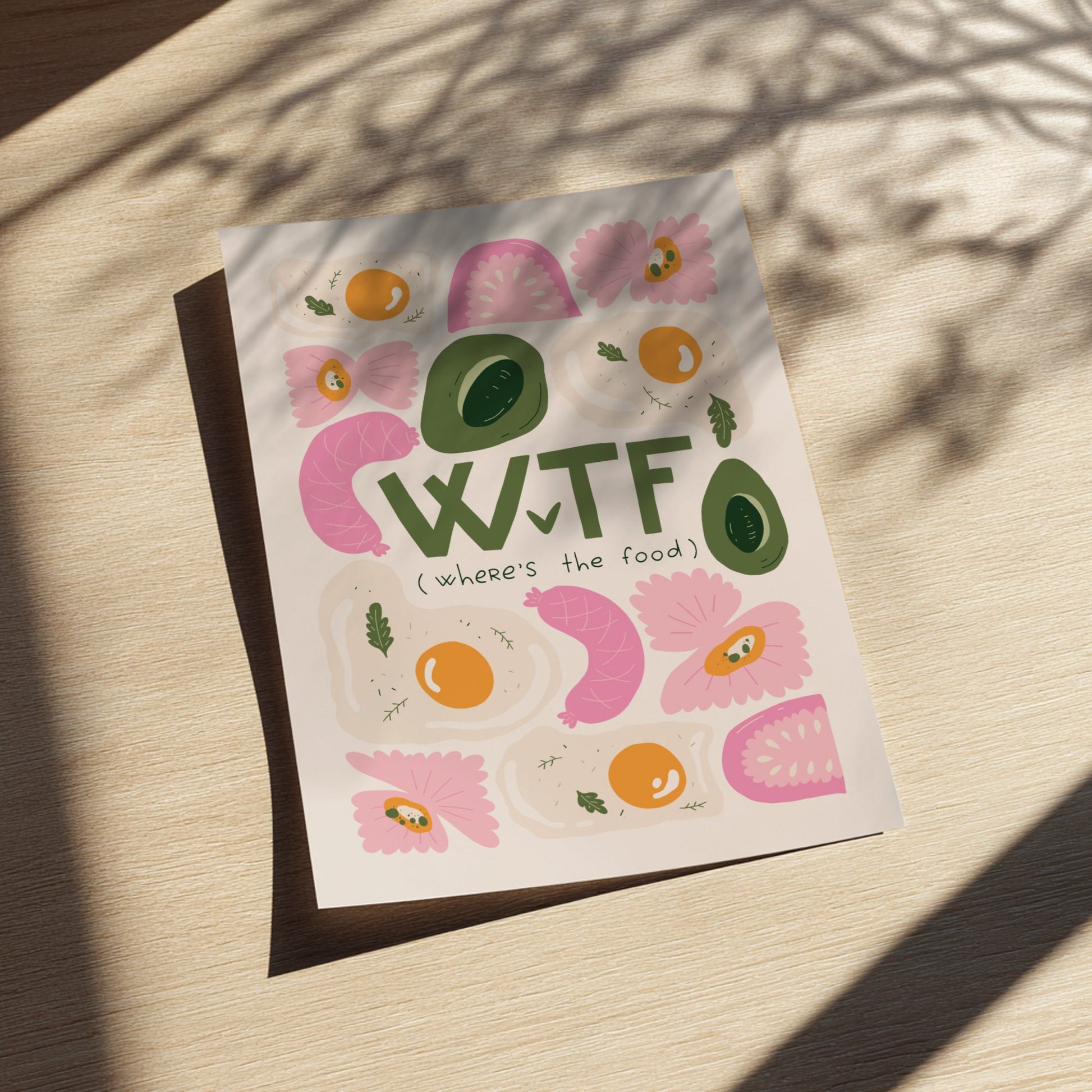 Colorful poster with 'WTF' and food illustrations on a wooden surface
