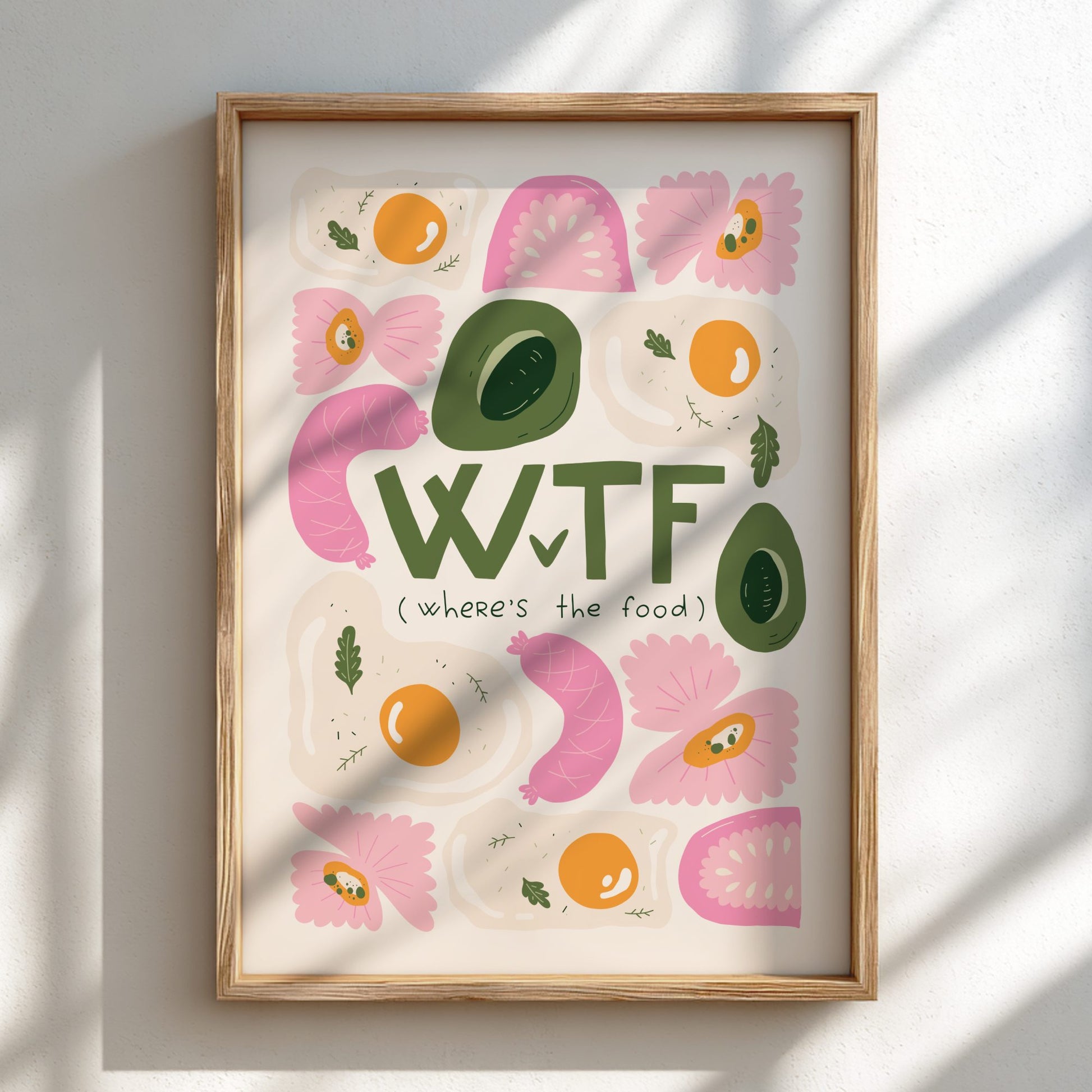 Framed artwork with colorful text and food-themed illustrations on a light background