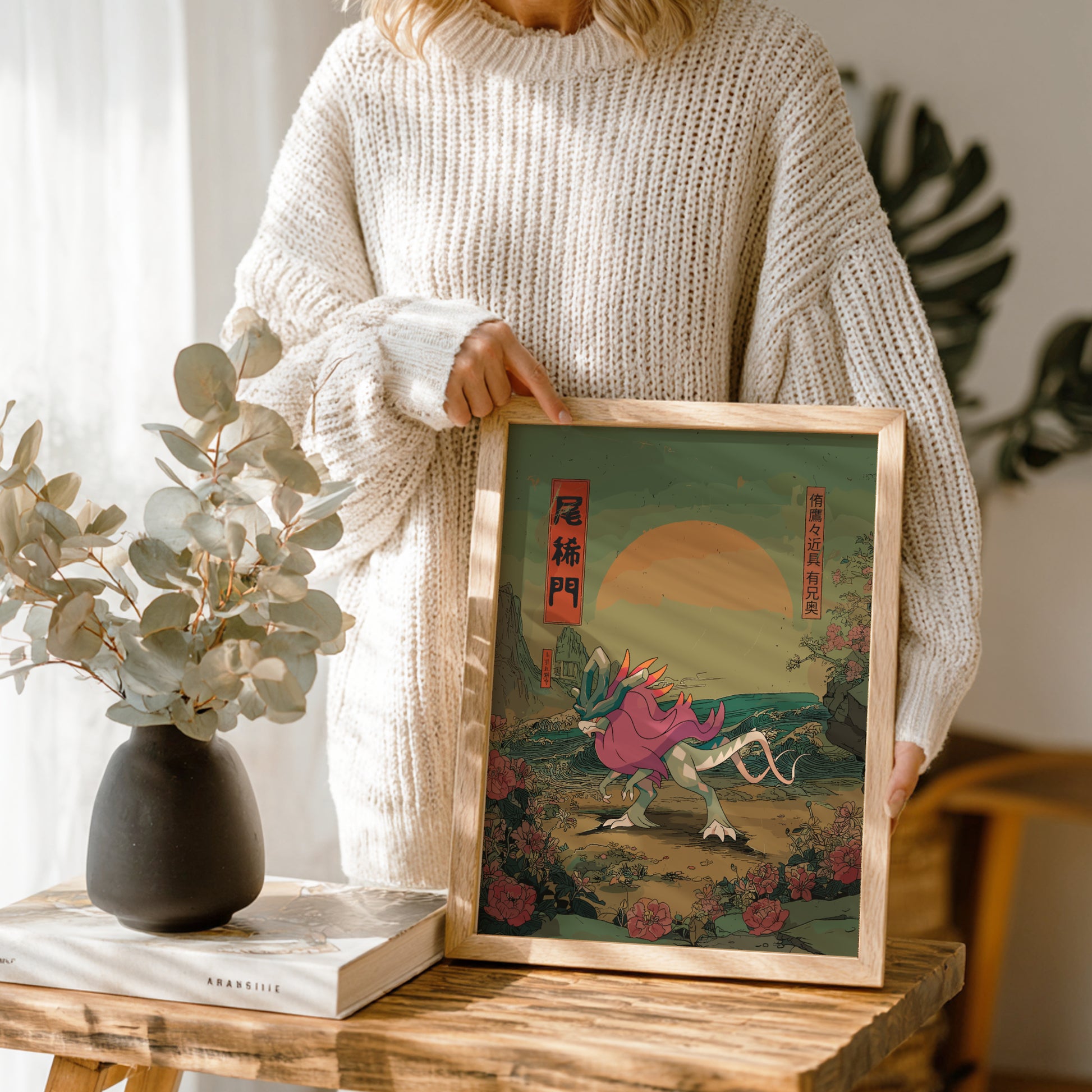 Person holding a framed artwork of Walking Wake Pokemon in a natural setting