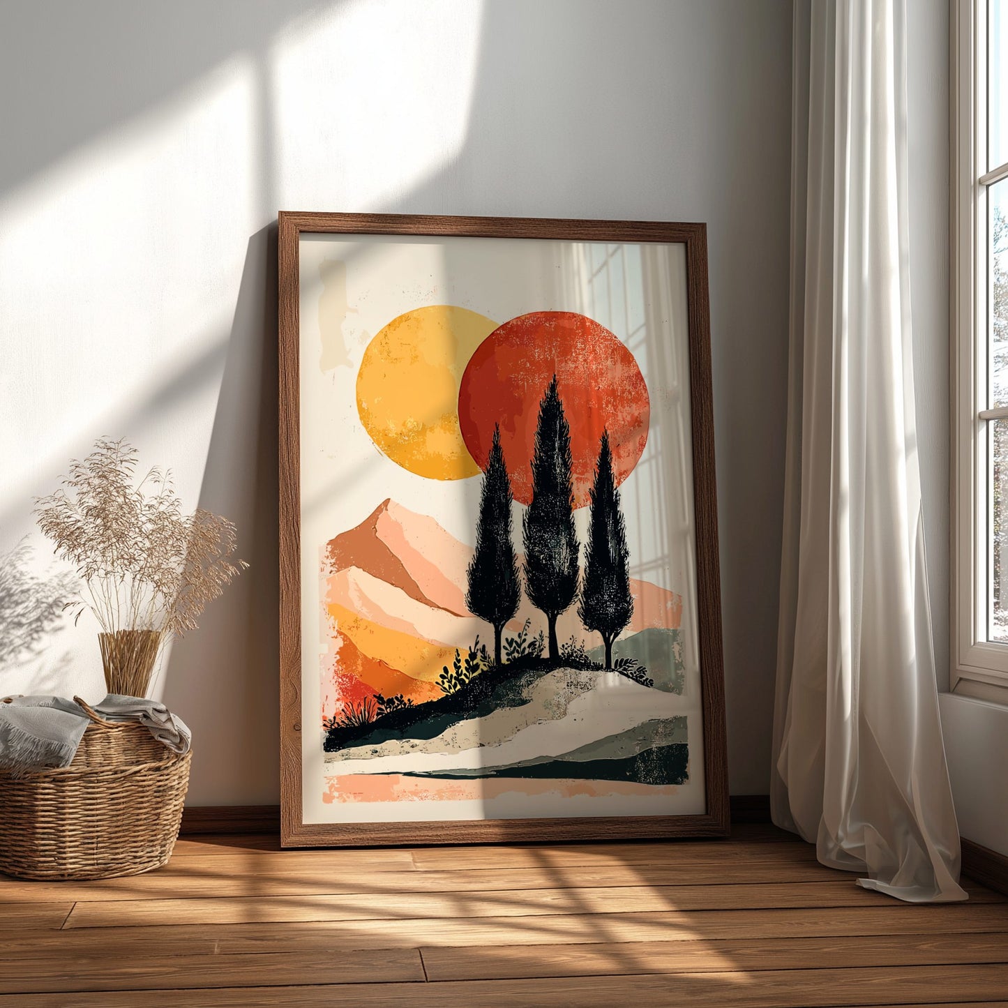 Framed artwork of a sunset landscape with trees in a room with natural light.