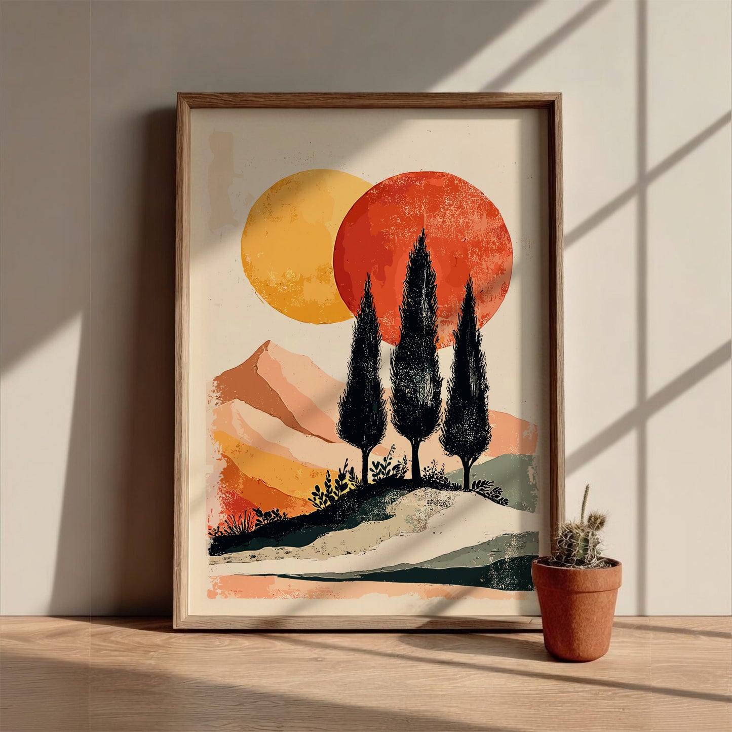 Framed artwork of a landscape with trees and sun on a wall.