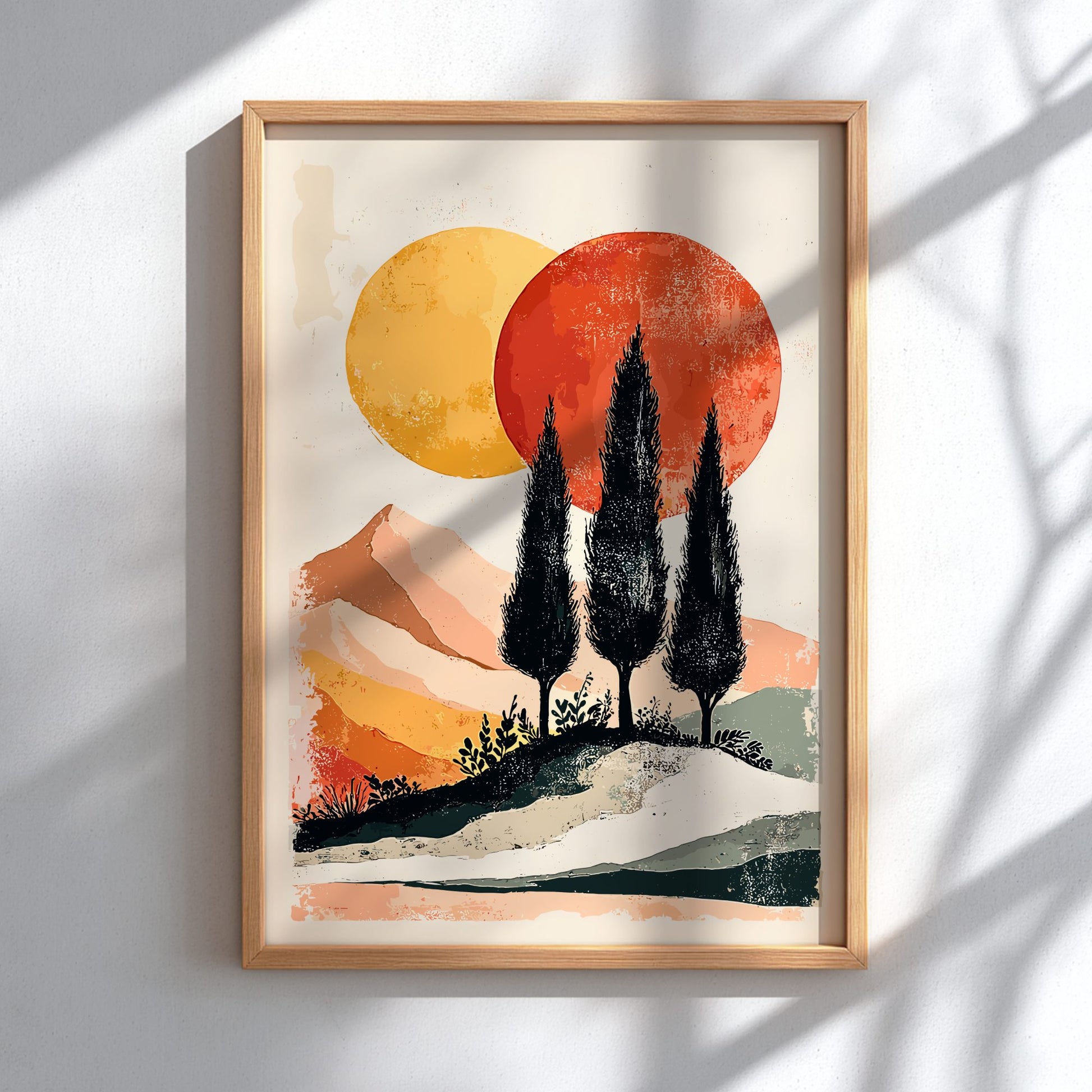 Framed artwork of a landscape with trees and abstract suns on a white wall.