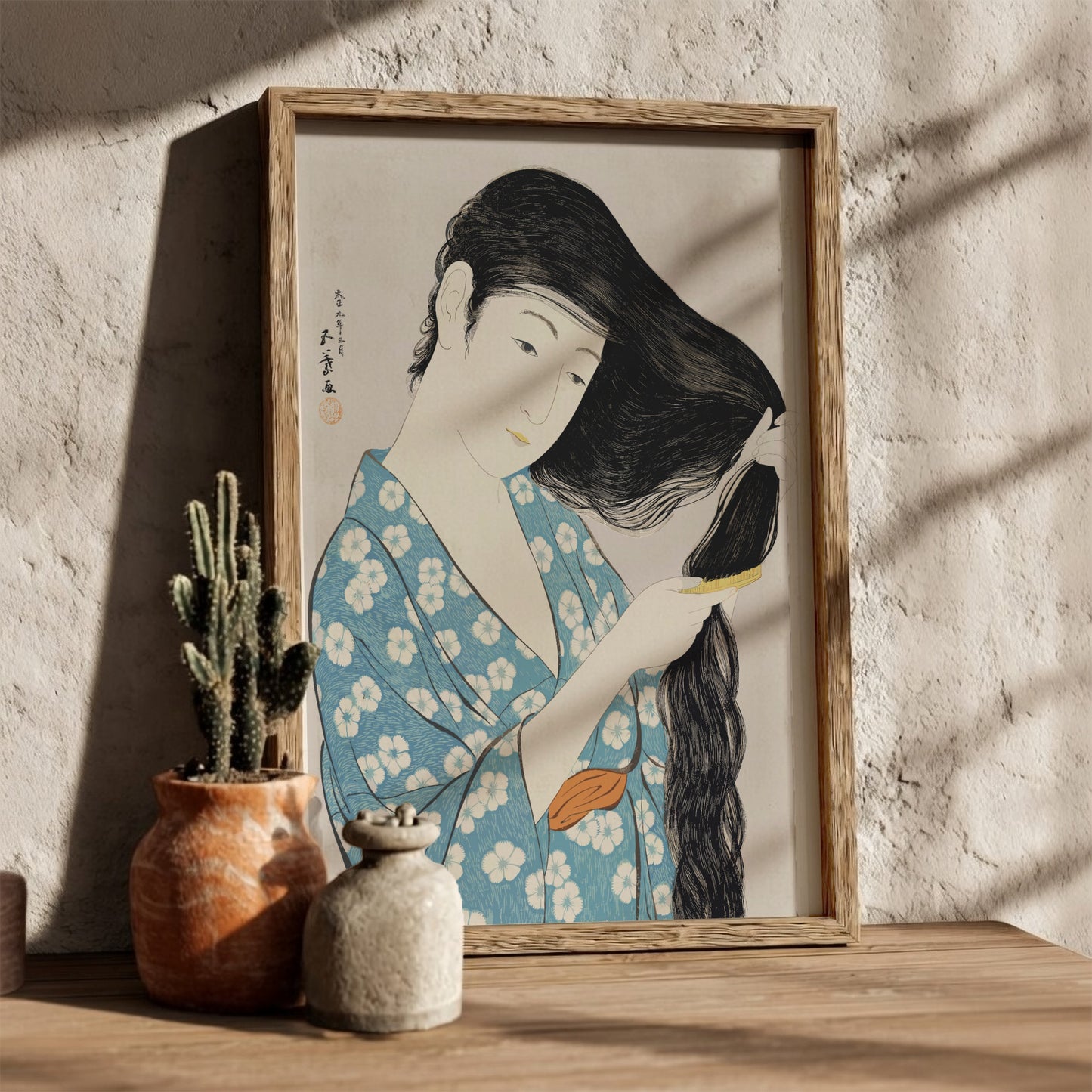 Poster of "Woman Combing Her Hair" by Goyō Hashiguchi, featuring a woman in a blue floral kimono brushing