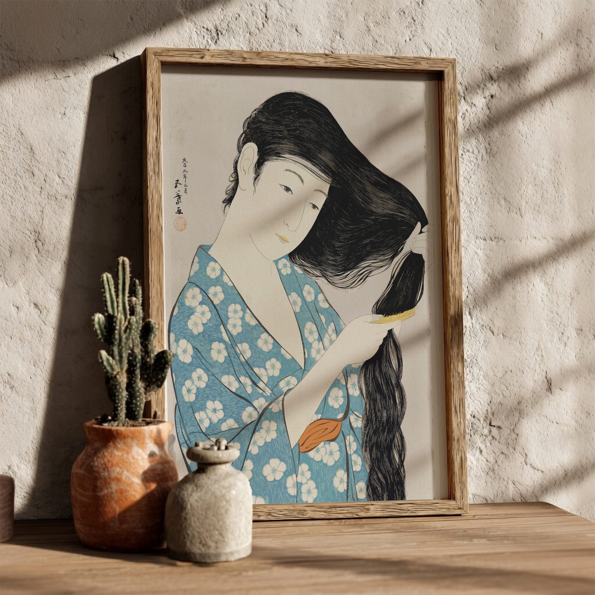 Poster of "Woman Combing Her Hair" by Goyō Hashiguchi, featuring a woman in a blue floral kimono brushing