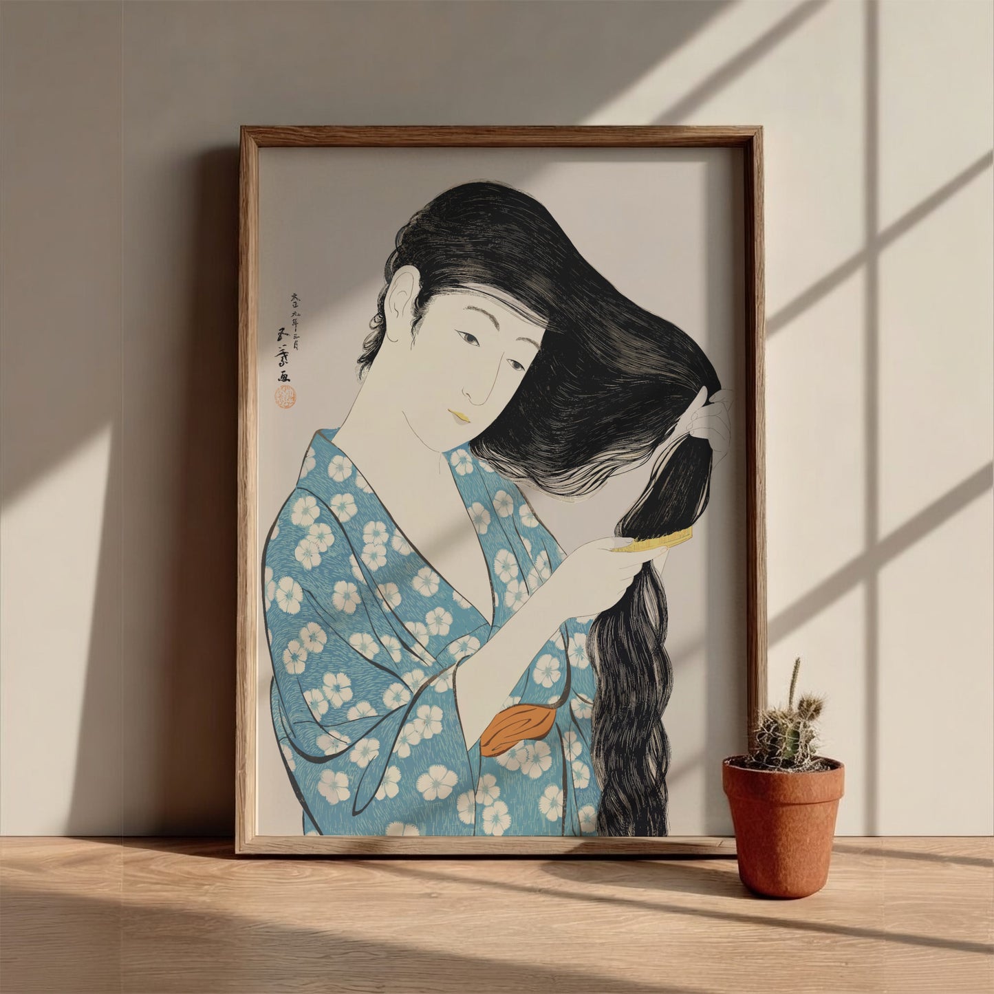 Poster of "Woman Combing Her Hair" by Goyō Hashiguchi, featuring a woman in a blue floral kimono brushing