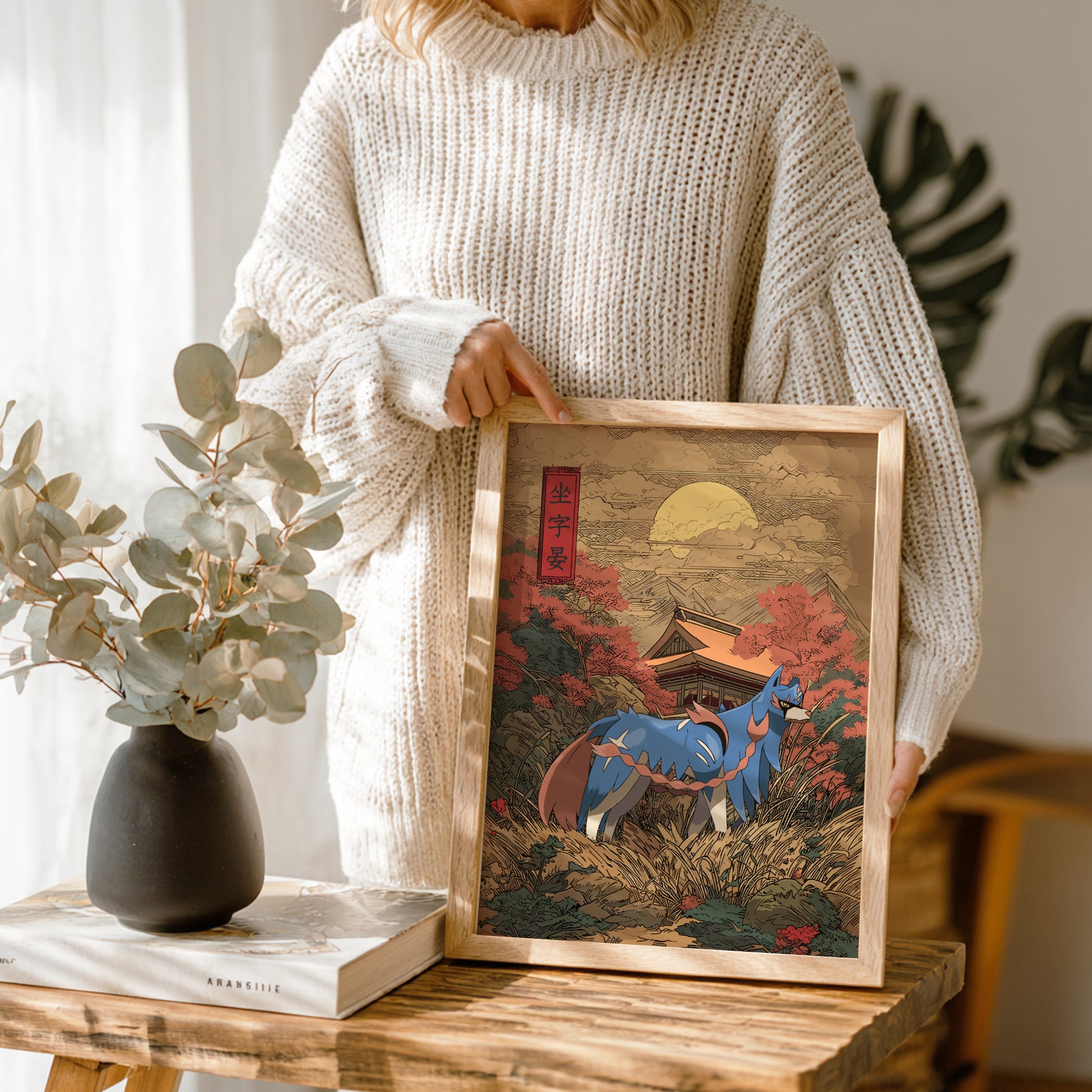Person holding a framed artwork of Zacian Pokemon in a scenic landscape