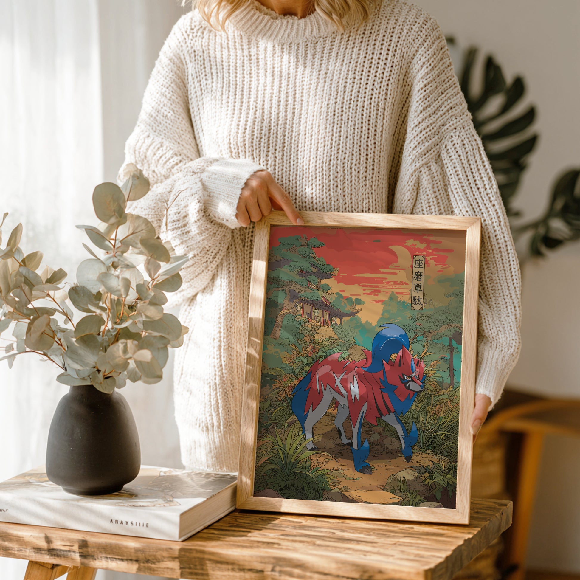 Person holding a framed artwork of Zamazenta Pokemon in a natural setting.