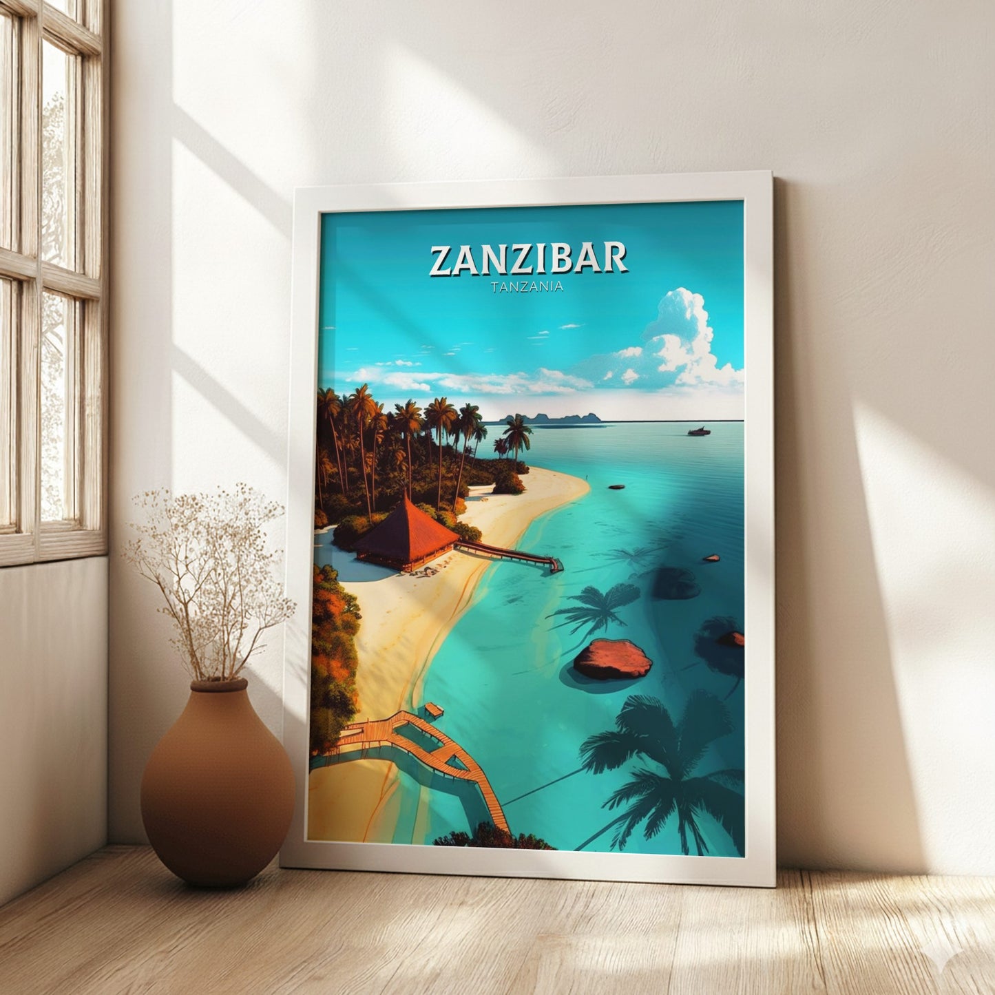 Framed artwork of Zanzibar with a beach and palm trees, placed on a wooden floor.