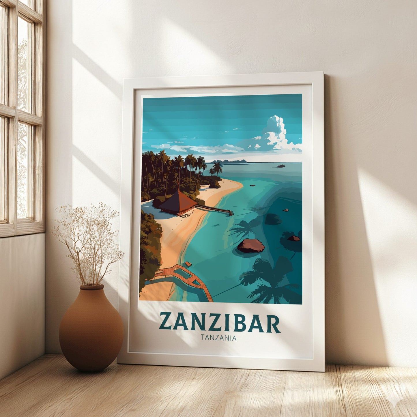 Framed artwork of Zanzibar with a beach scene, placed on a wooden floor with a vase beside it.