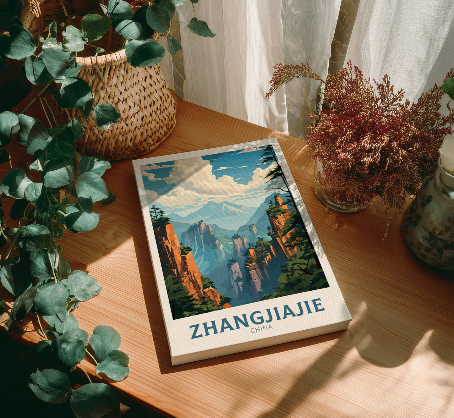 Canvas with Zhangjiajie illustration on a wooden table with plants