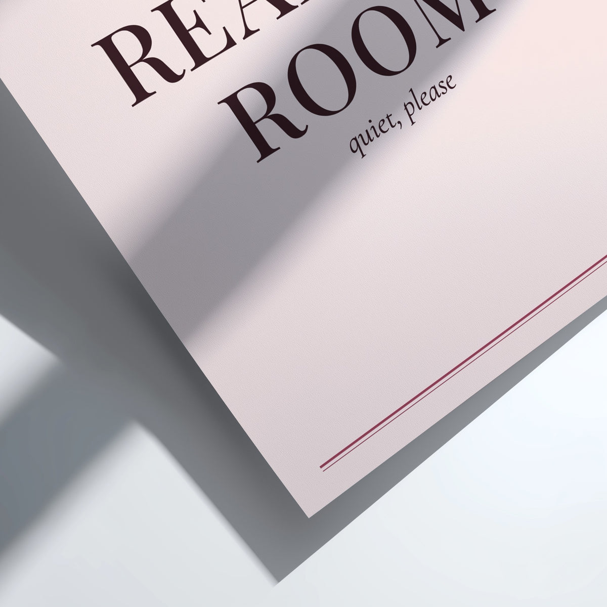 A close-up of a light pink or off-white paper sign with dark brown text reading 'REACH ROOM' and smaller text 'quiet, please' below, photographed on a white surface with a strong diagonal shadow.