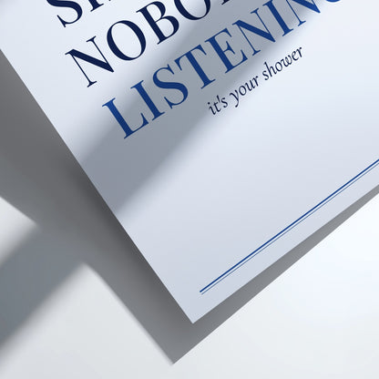 A close-up of a printed card or sign with partial text reading 'LISTENING' and 'it's your shower' on a white background, cast with strong diagonal shadows.