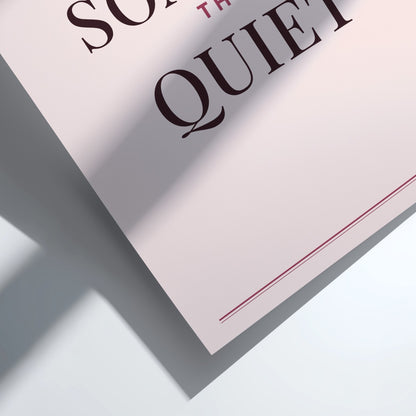 A close-up of a printed sign or poster with the words 'SO Quiet' in dark brown serif lettering on a pale pink background, casting a sharp shadow on a white surface.
