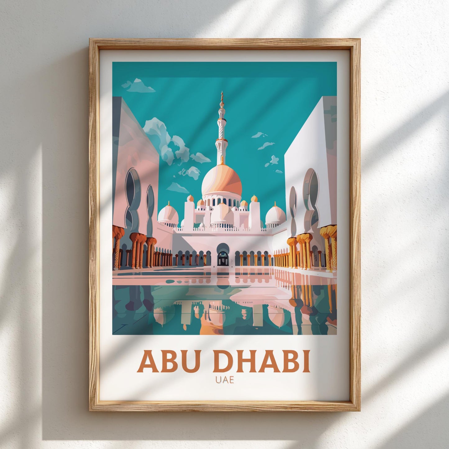 Framed artwork of a mosque with 'Abu Dhabi UAE' text on a light background