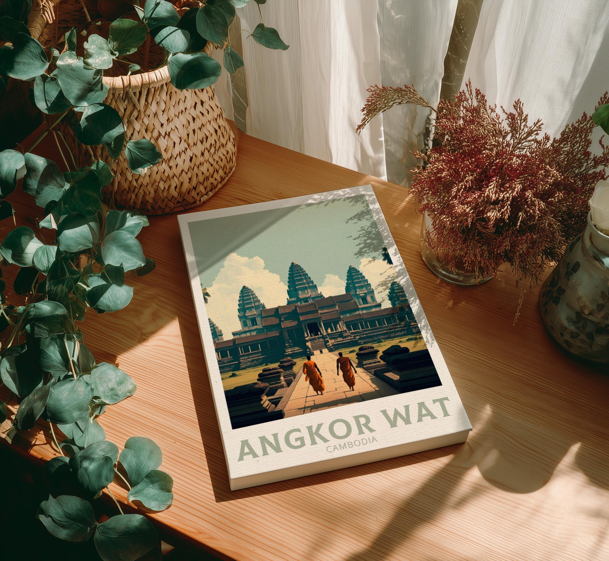 Canvas 'Angkor Wat' on a wooden table with plants around