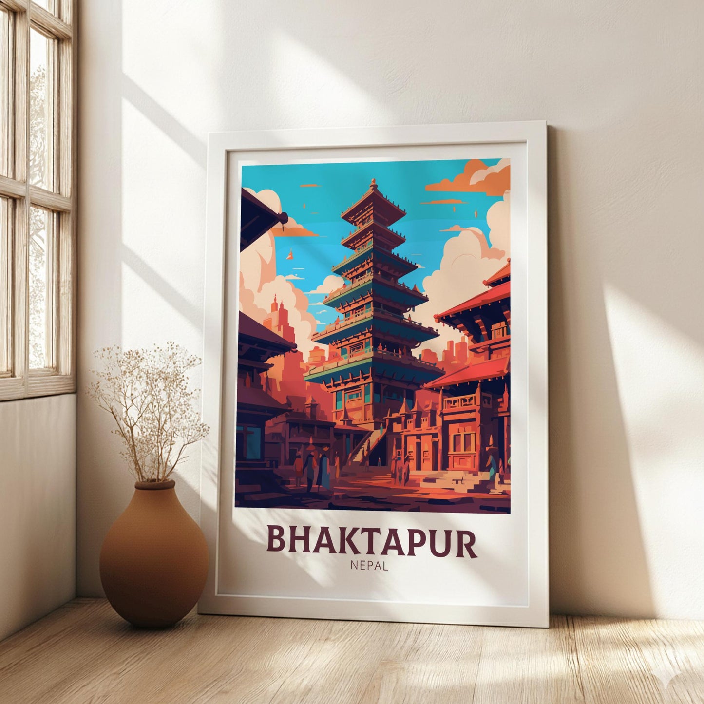 Framed poster of Bhaktapur, Nepal with a traditional building design, placed on a wooden floor.