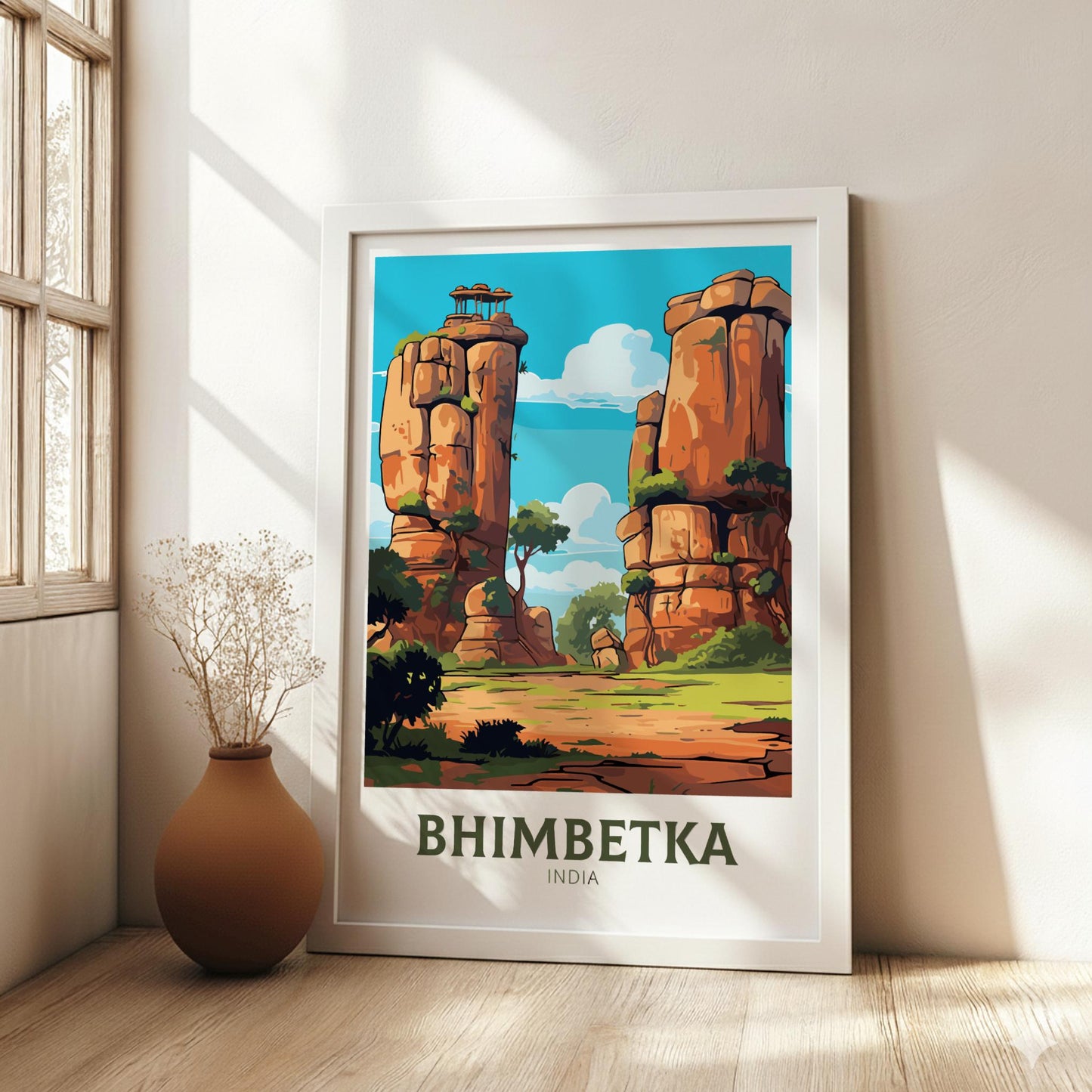Framed poster of Bhimbetka, India with rocky landscape design, placed on a wooden floor.