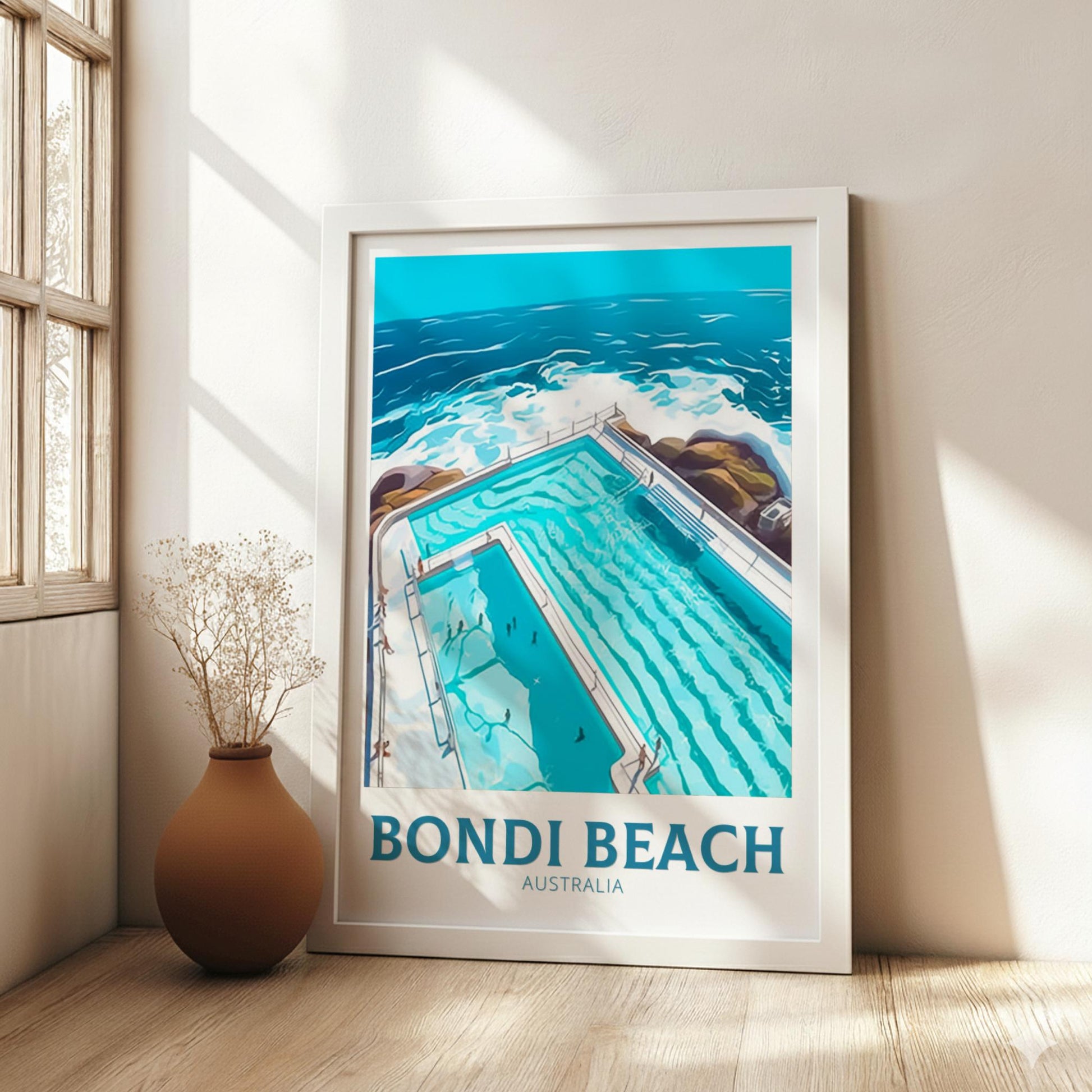 Framed artwork of Bondi Beach, Australia with a vase on a wooden floor.