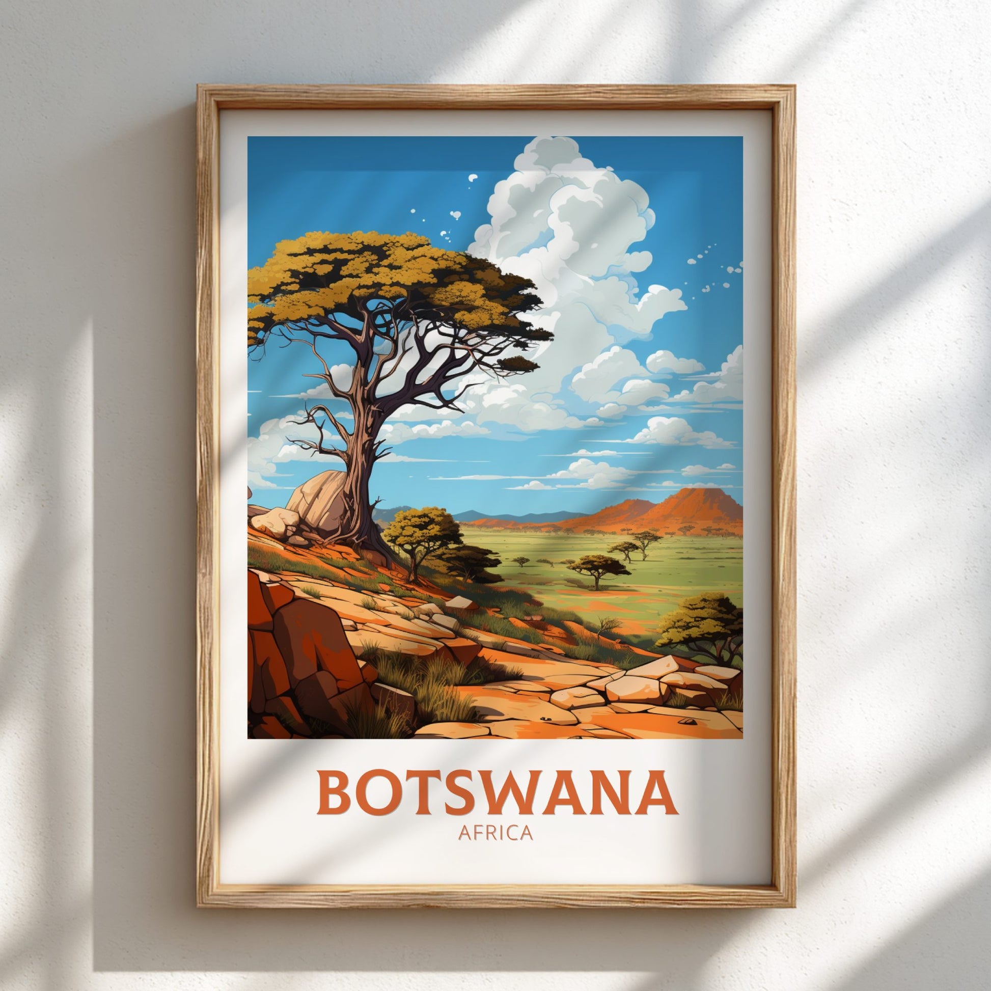 Framed artwork of a scenic landscape with 'Botswana Africa' text on a white wall.
