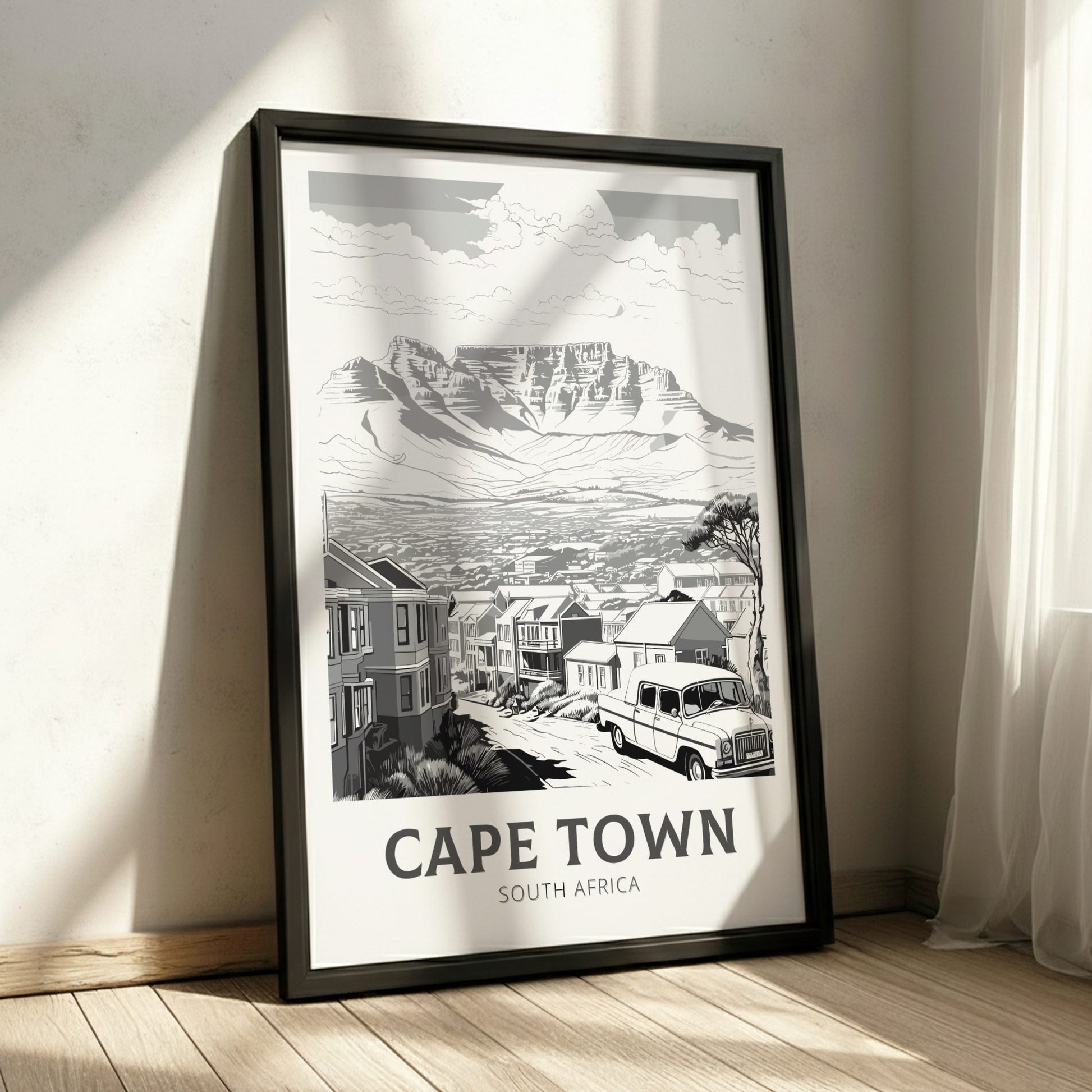 Framed black and white print of Cape Town, South Africa on a wall.