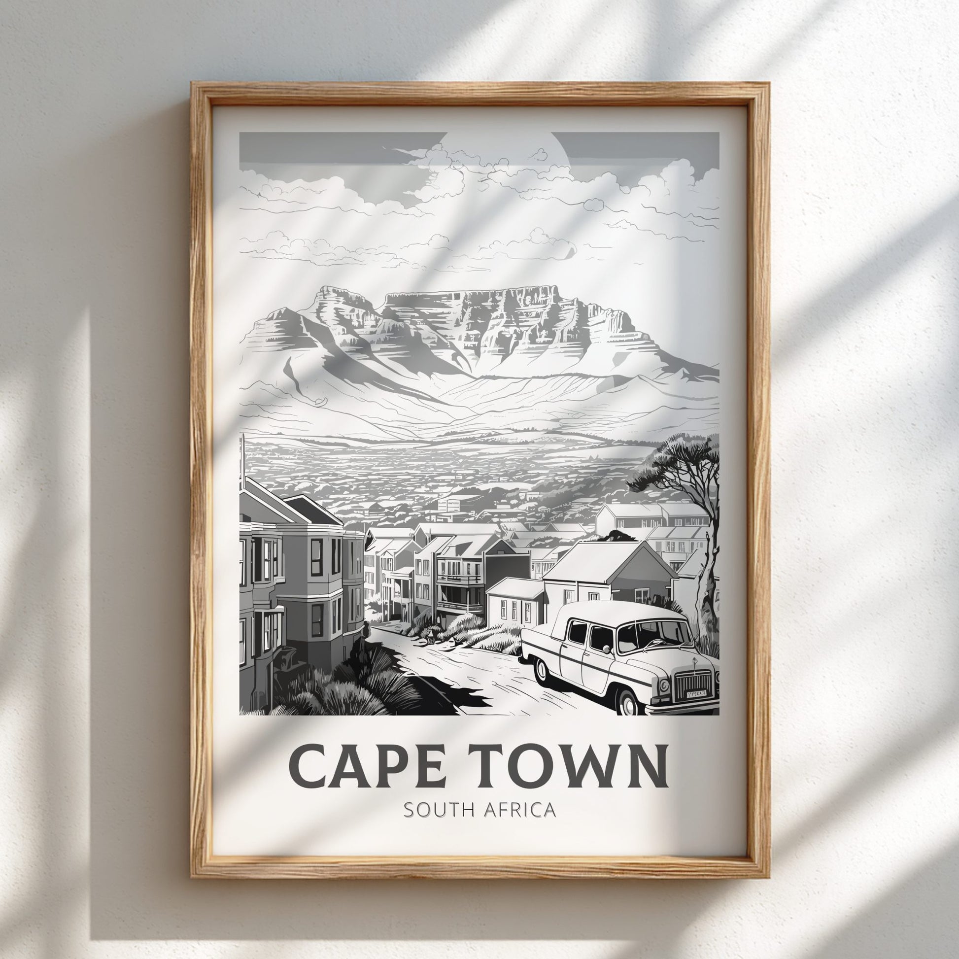 Framed artwork of Cape Town, South Africa with a mountain and street scene.