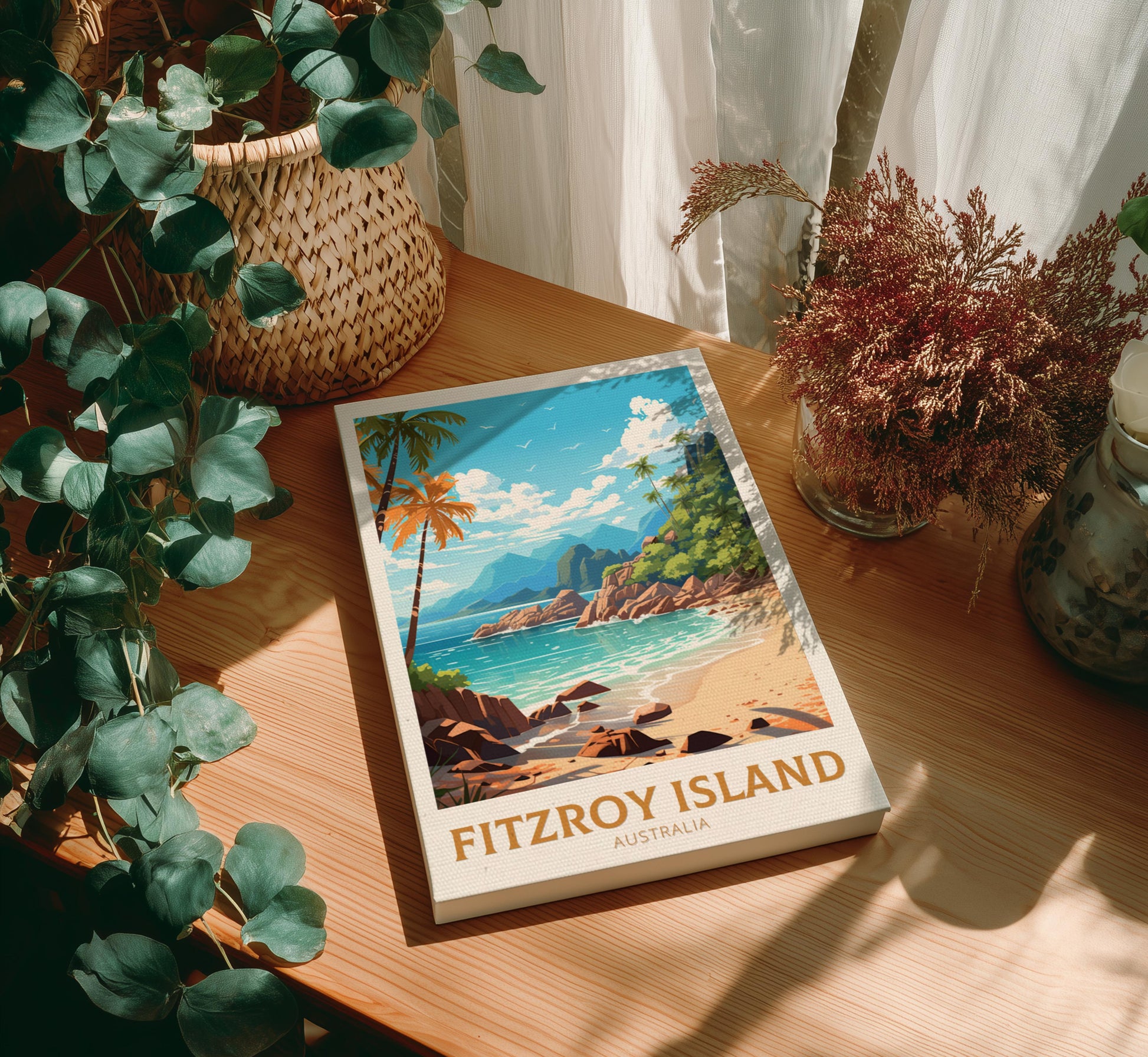 Canvas of 'Fitzroy Island, Australia' on a wooden table with plants.