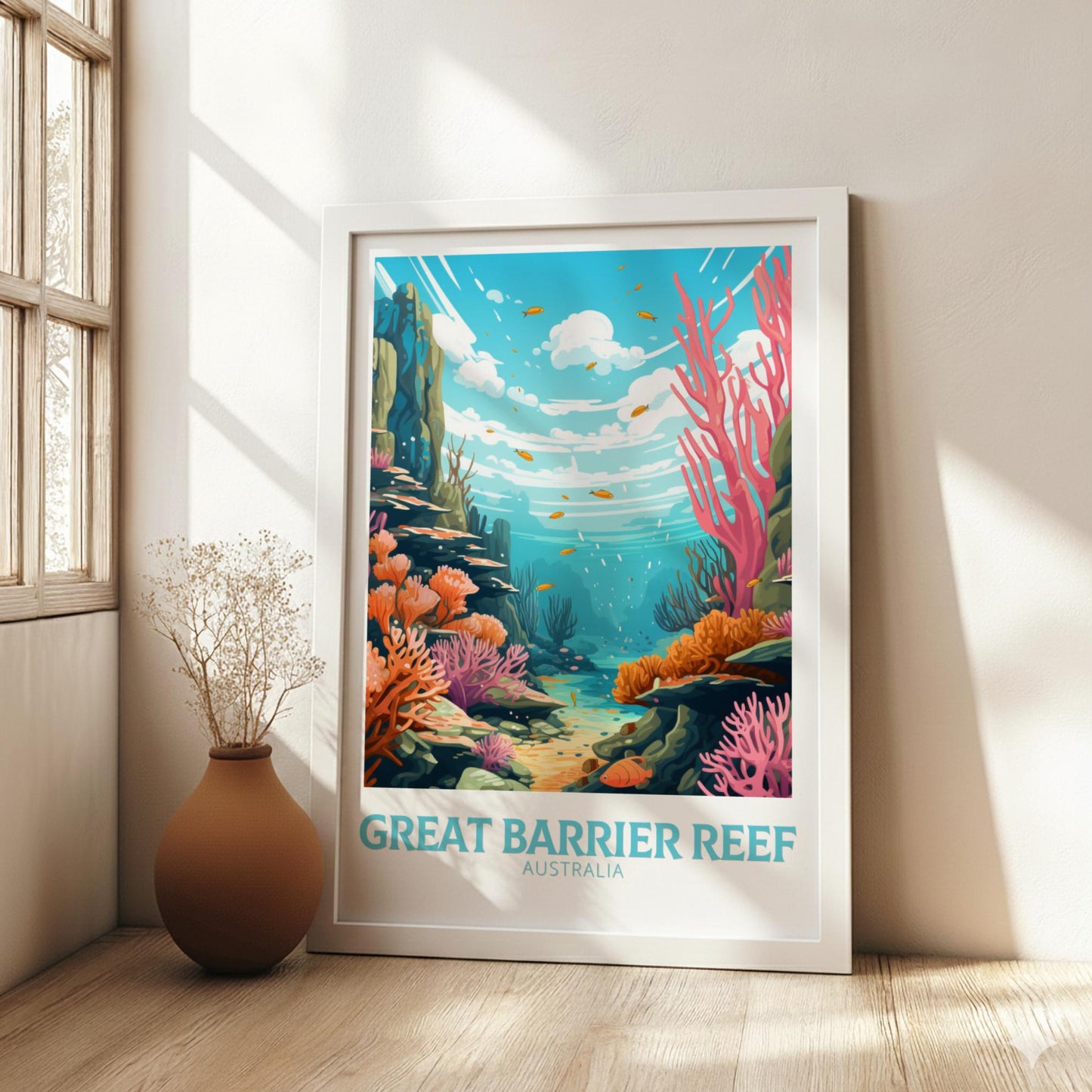 Framed poster of the Great Barrier Reef in a room with a vase on a wooden floor.