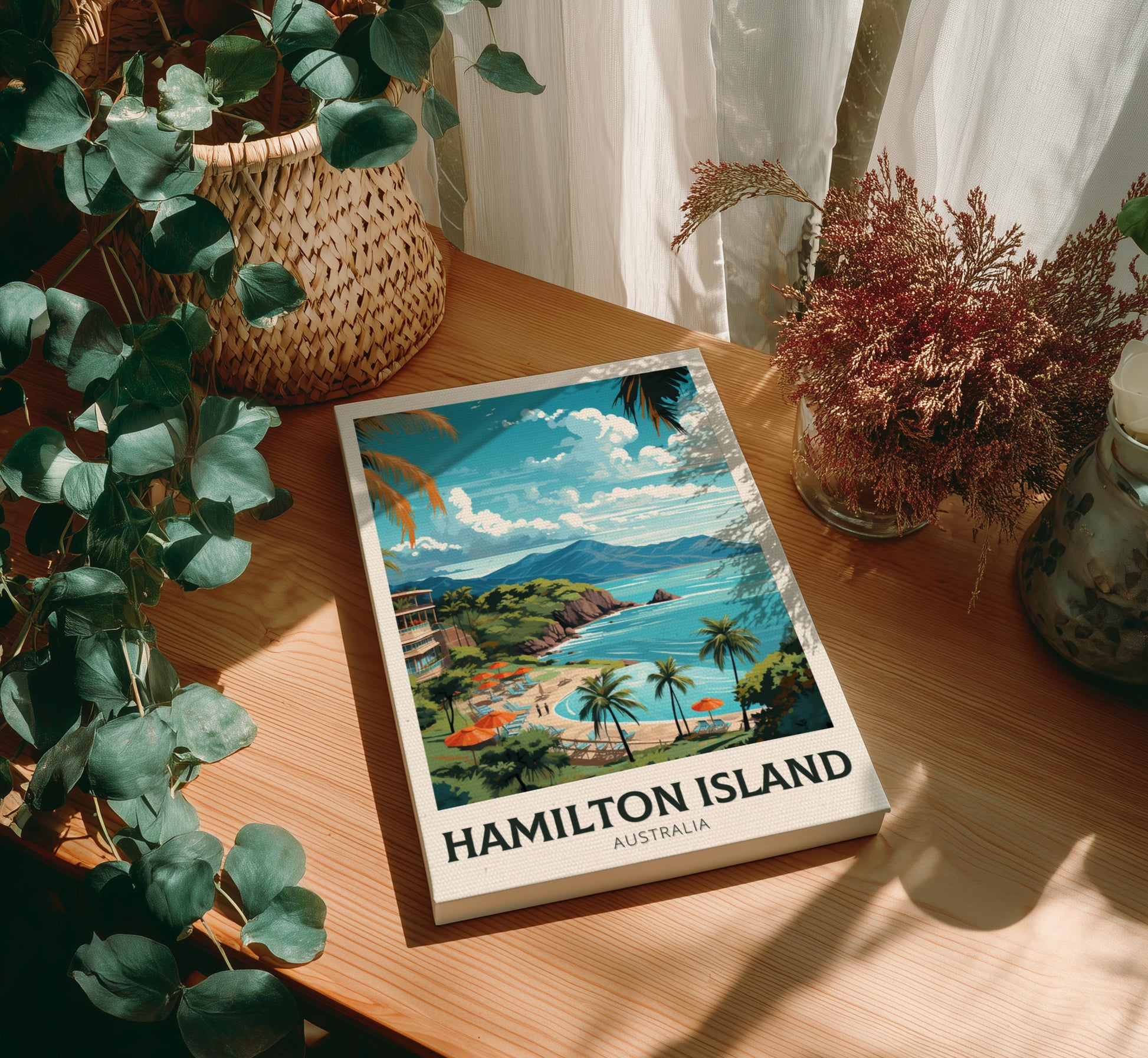 Canvas of Hamilton Island, Australia on a wooden surface with plants around