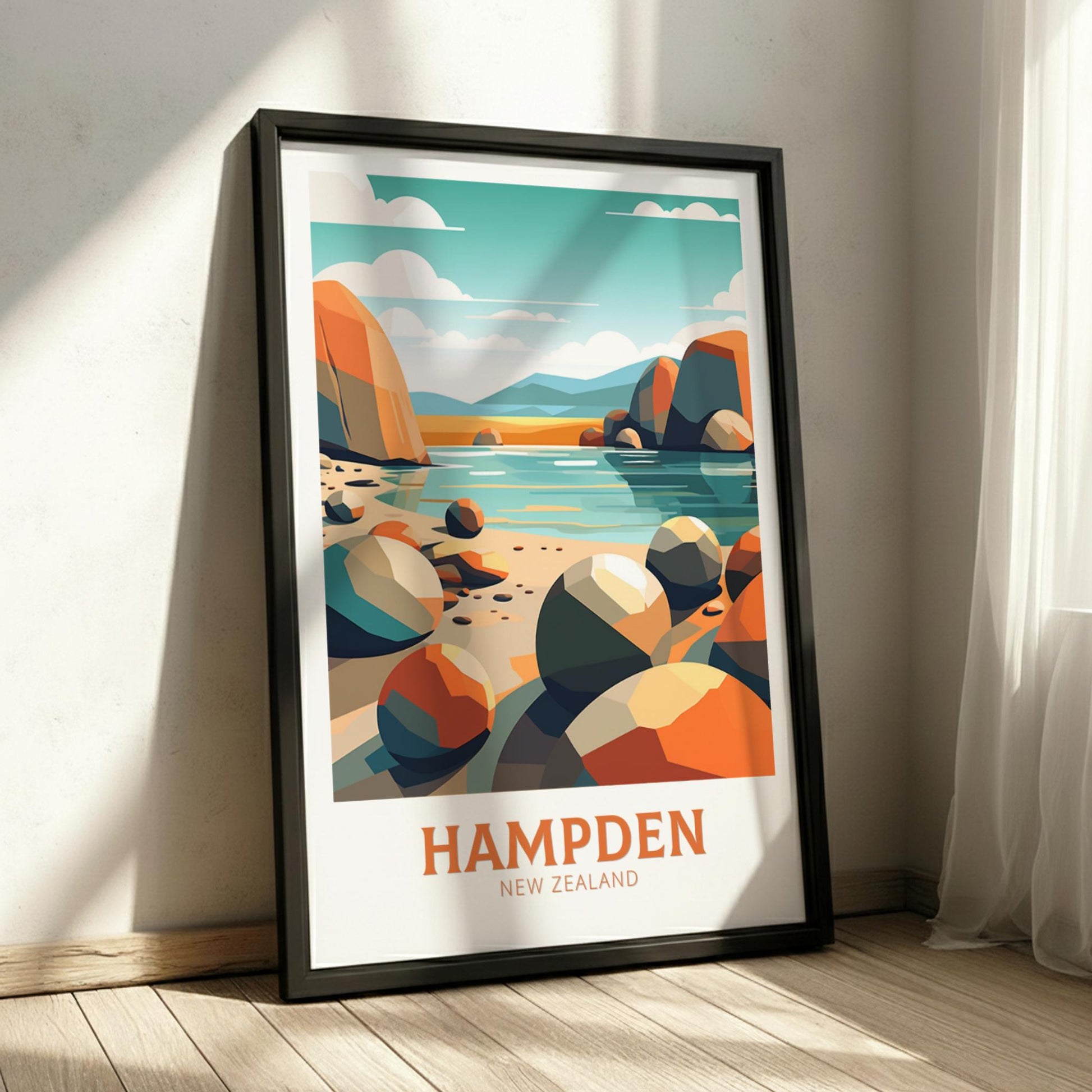 Framed poster of a beach scene with colorful rocks and 'Hampden New Zealand' text on a wall.
