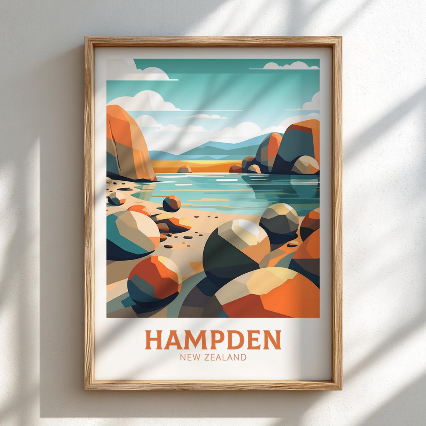 Framed artwork of a scenic landscape with 'Hampden, New Zealand' text on a white wall.