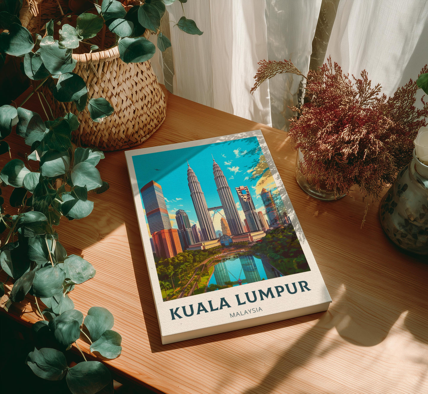 Canvas with Kuala Lumpur cover on a wooden table with plants