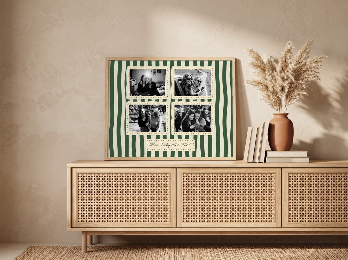 A framed personalized photo collage with green and white vertical stripes and four black-and-white family photos, displayed on a light wood cabinet in a styled room setting.