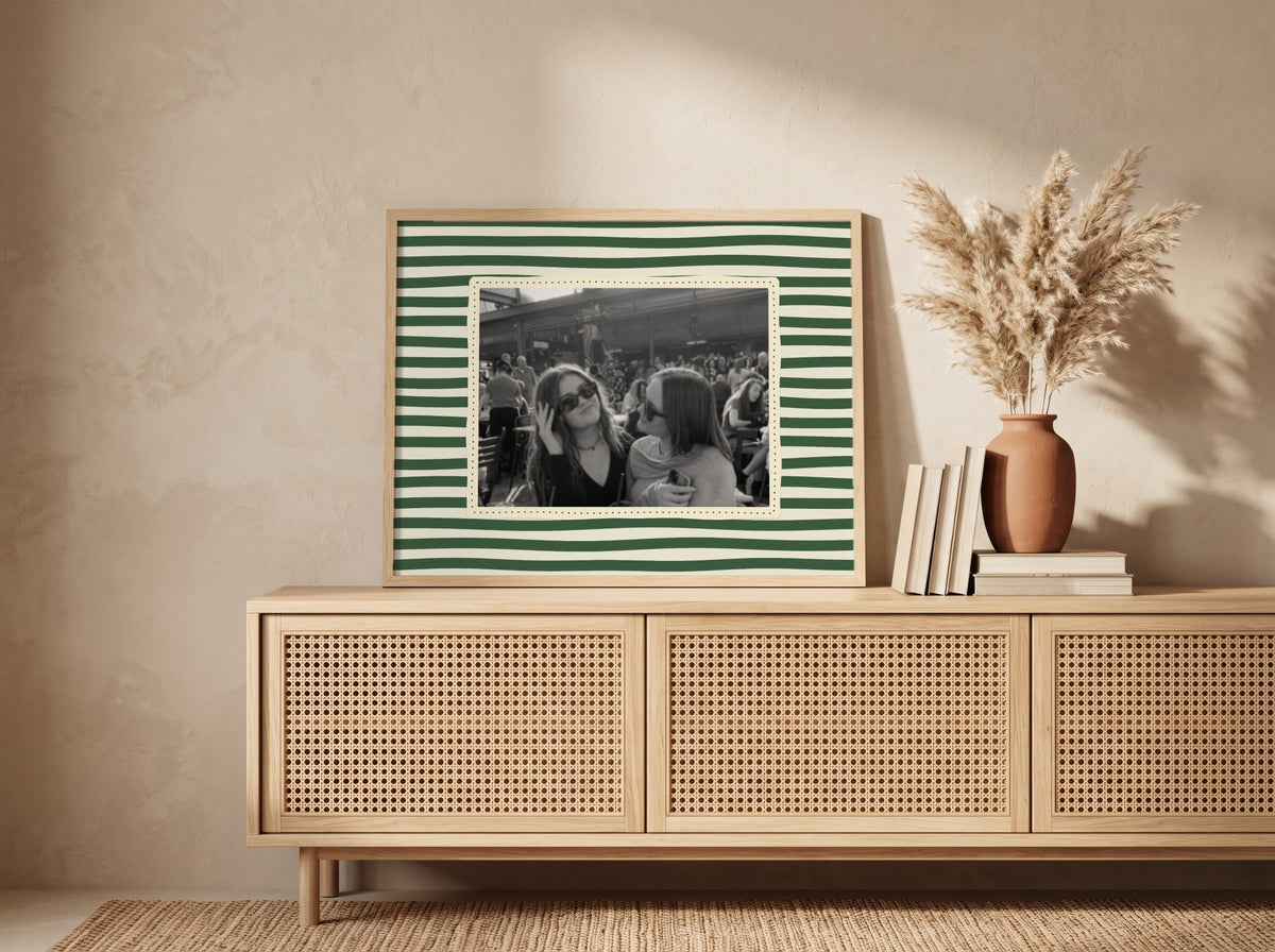 Personalised Striped Landscape Photo Print in an oak frame leaning against a wall in a boho room