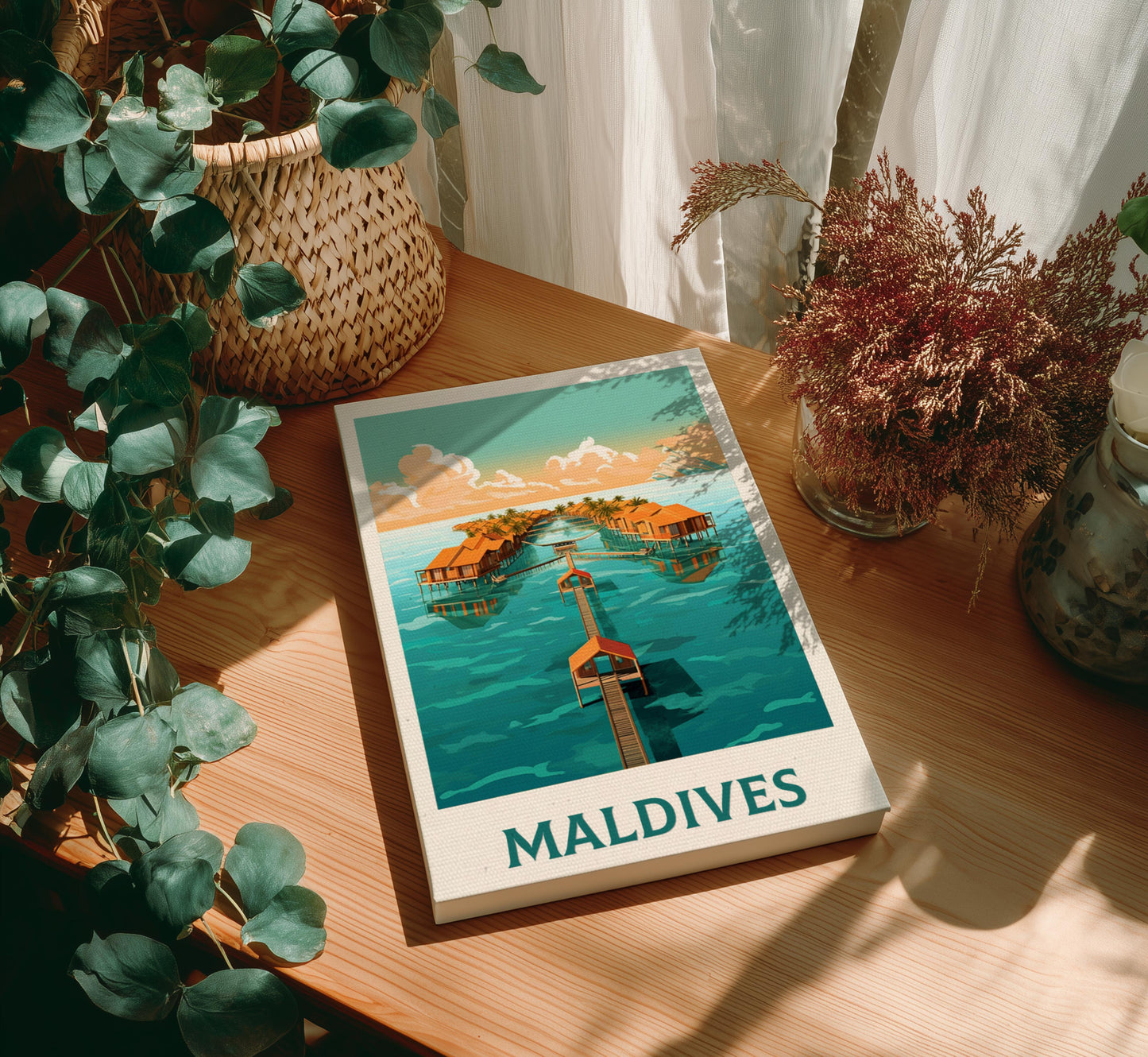 Canvas of 'Maldives' with a scenic illustration on a wooden table with plants.