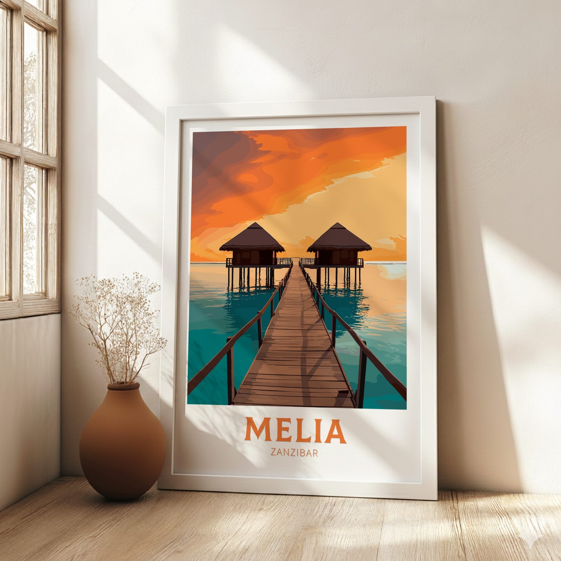 Framed artwork of a tropical scene with 'Melia Zanzibar' text, placed on a wall in a bright room.