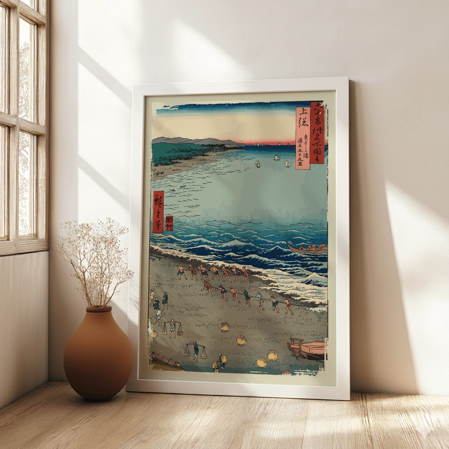 Famous art poster of Utagawa Hiroshige's woodblock print 'Fishermen Pulling a Boat' on a beach.
