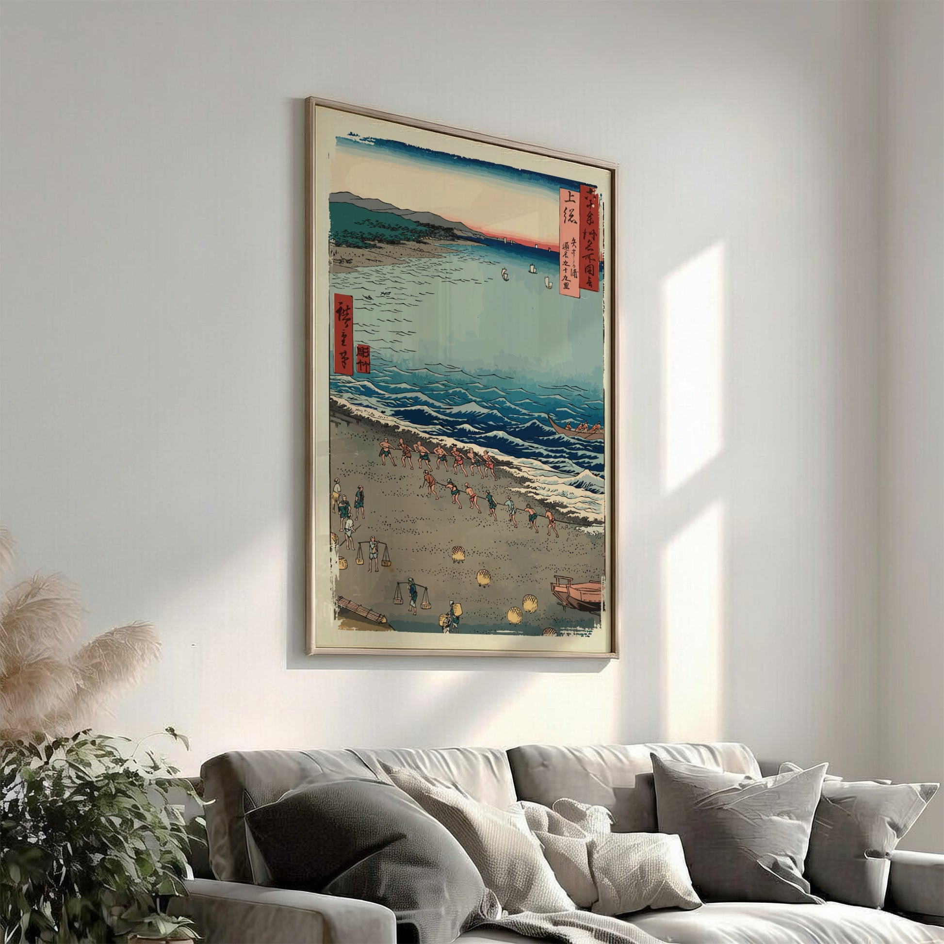 Famous art poster of Utagawa Hiroshige's woodblock print 'Fishermen Pulling a Boat' on a beach.