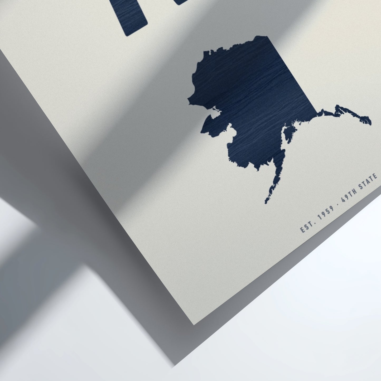 Navy blue map of Alaska on a light gray background