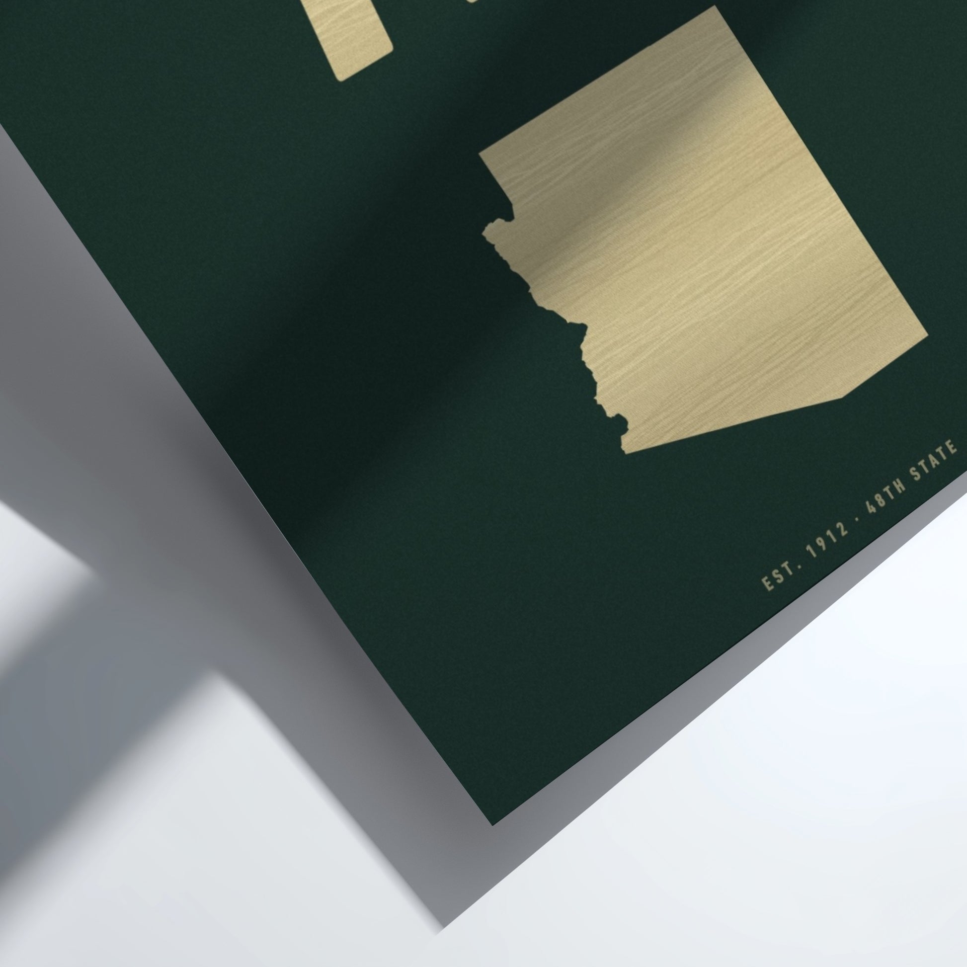 Gold map of Arizona on a dark green background