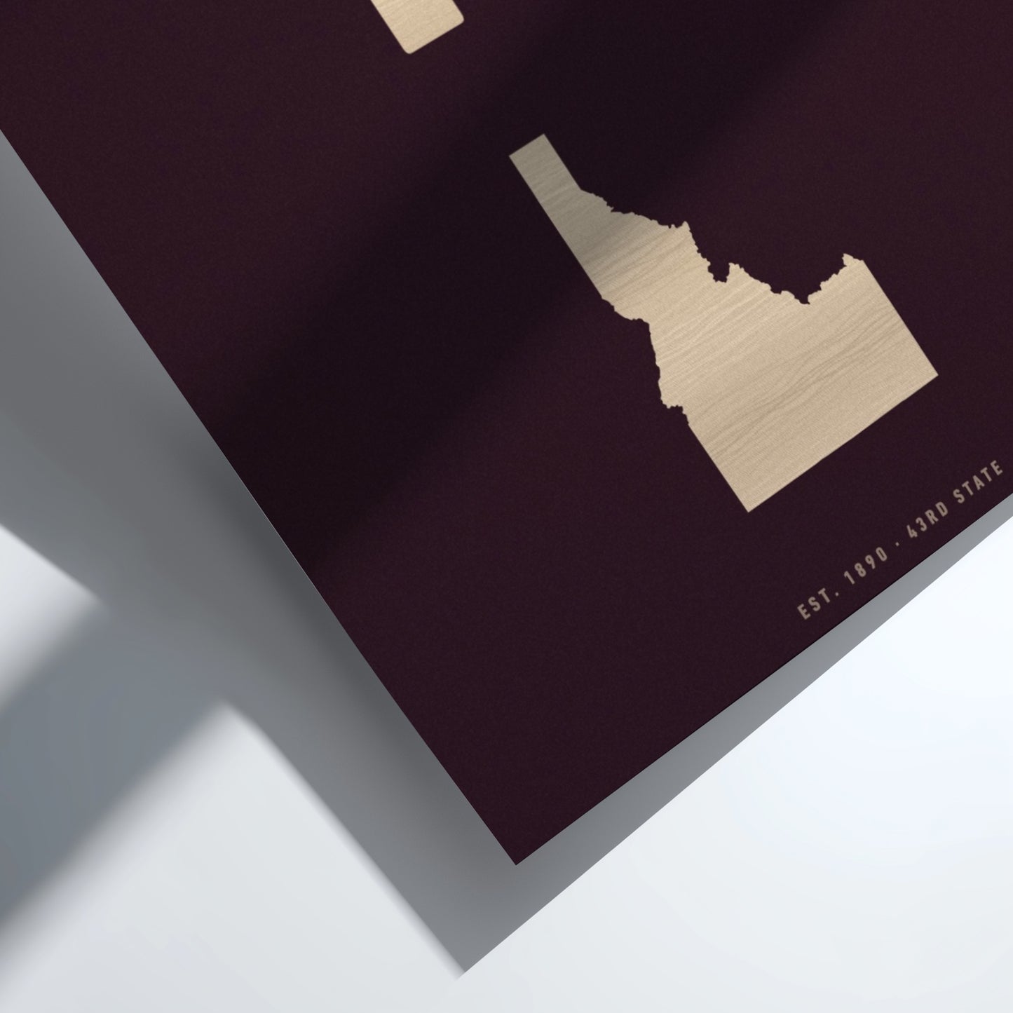 Idaho poster featuring a burgundy background and state outline, perfect for USA states decor.