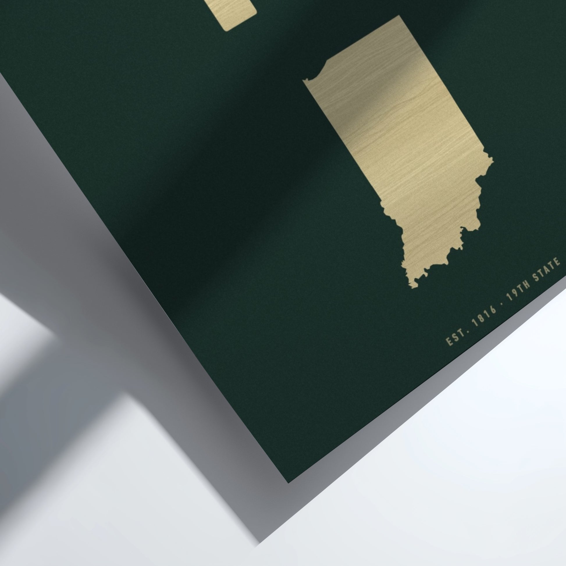 Gold map of Indiana on a dark green background