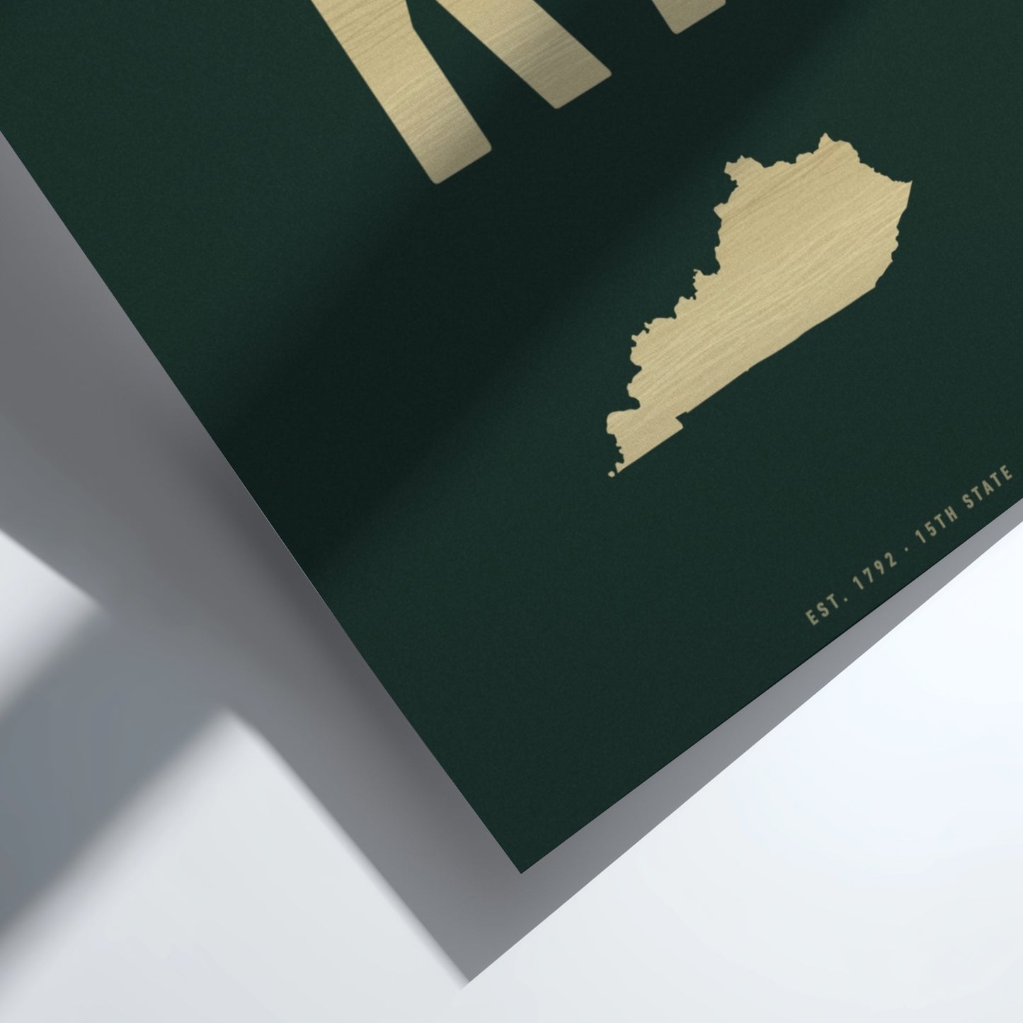 Gold map of Kentucky on a dark green background