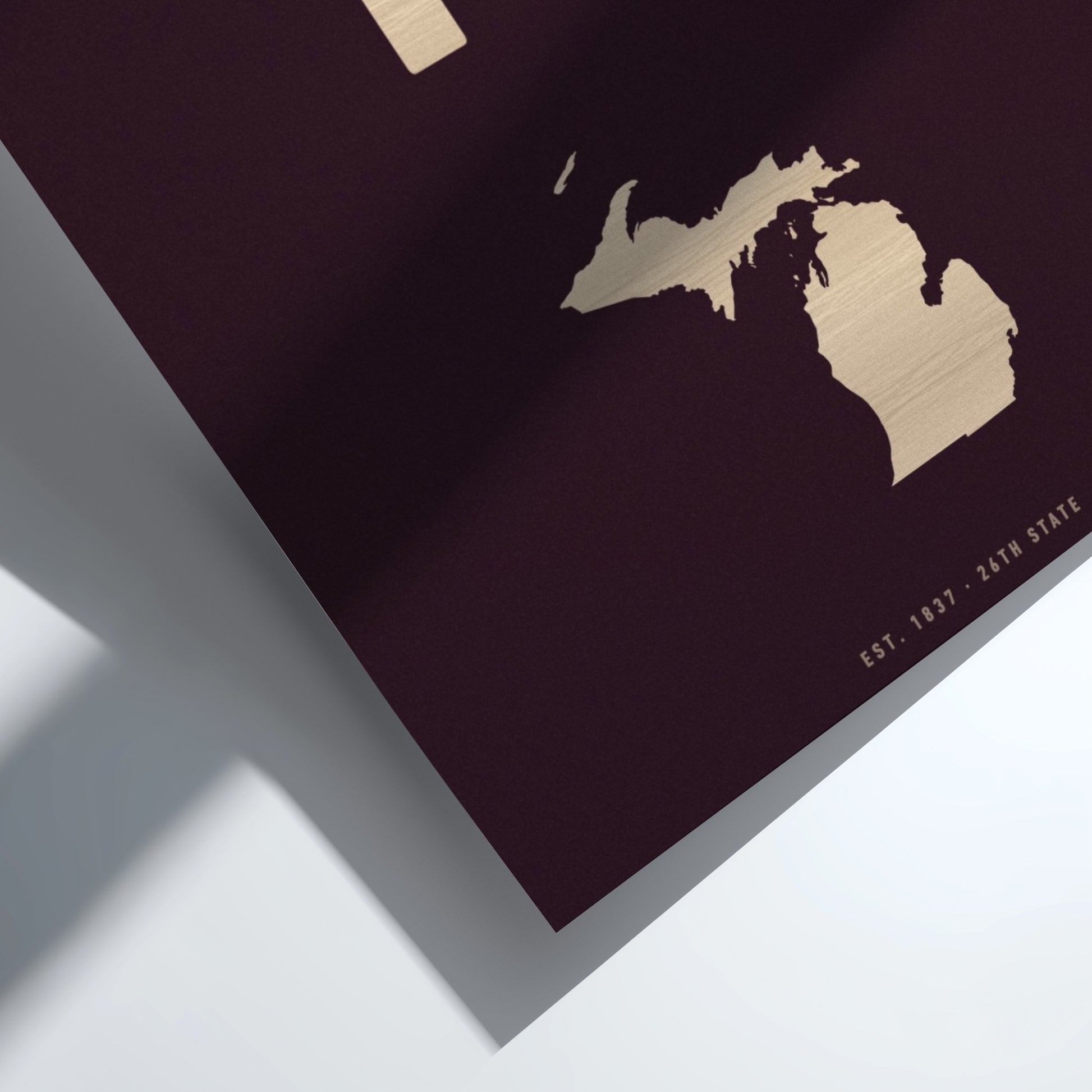 Map of Michigan on a dark surface with gold outline