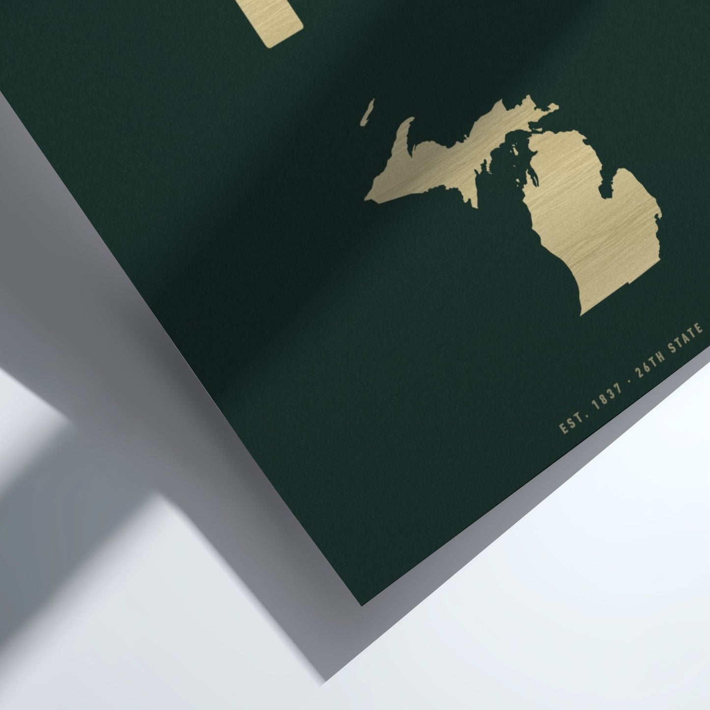 Gold map of Michigan on a dark green background