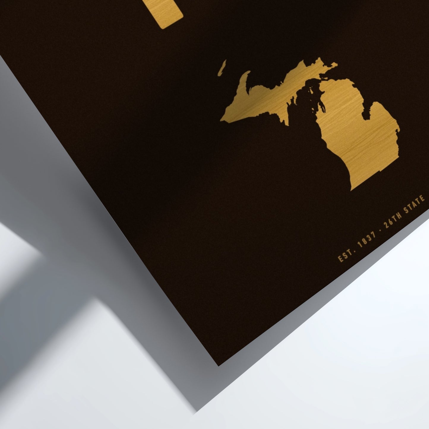 Gold map of Michigan on a black background