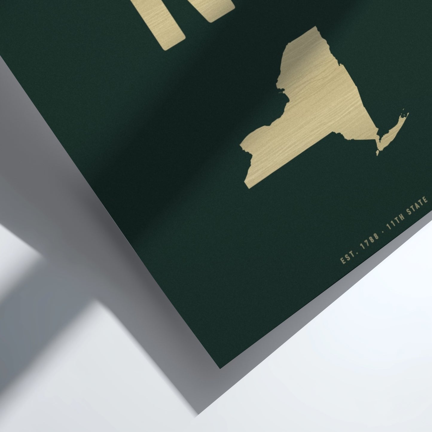 Gold map of New York State on a green background
