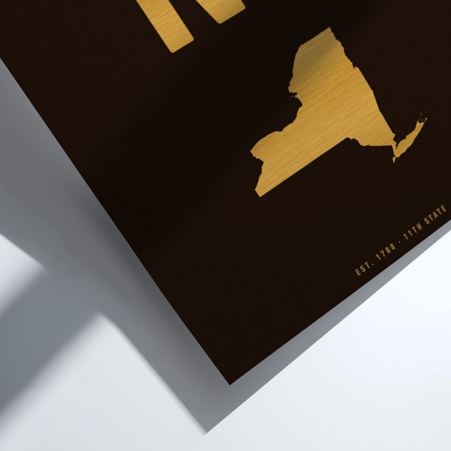Gold map of New York State on a black background