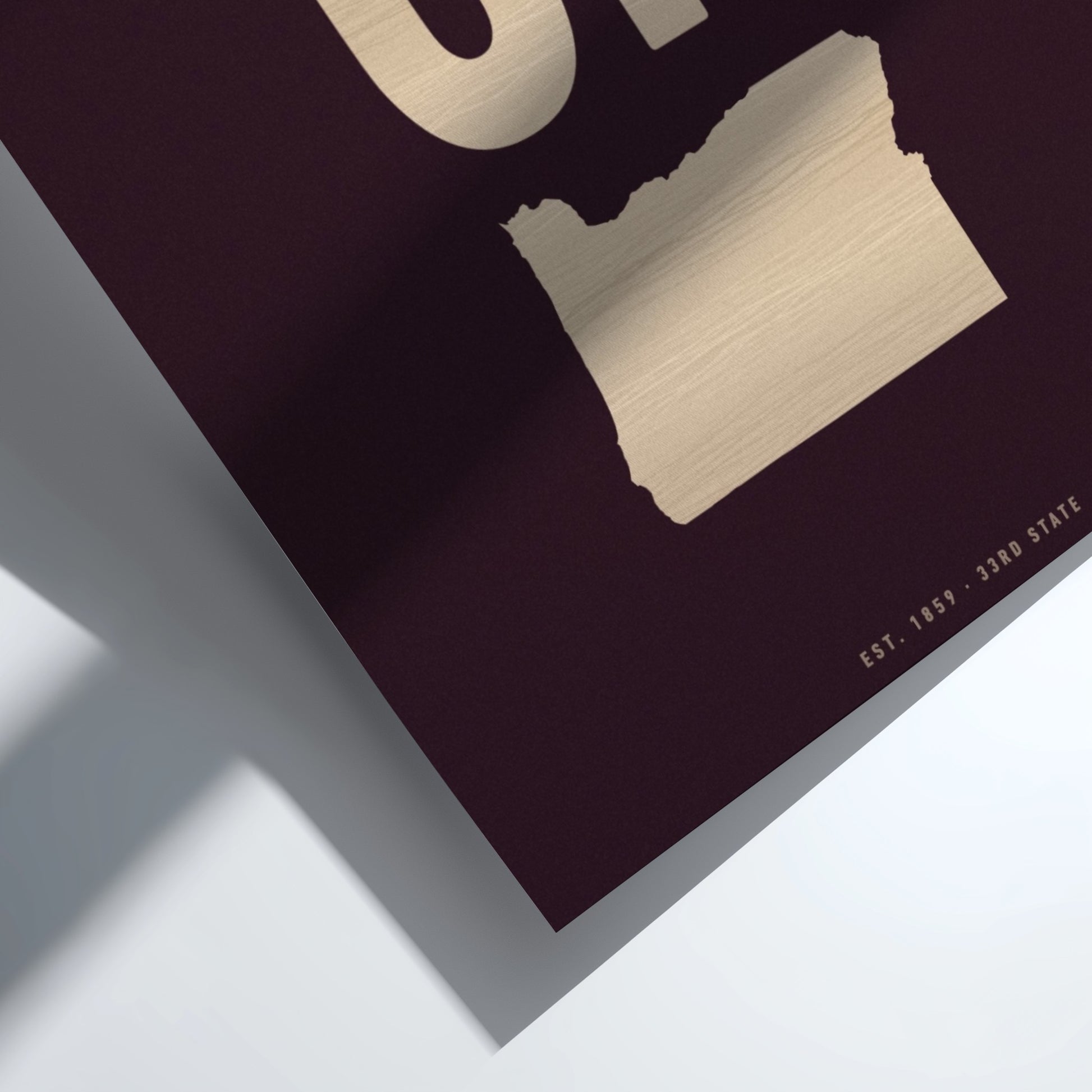 Close-up of a book with a map of Oregon on a dark cover