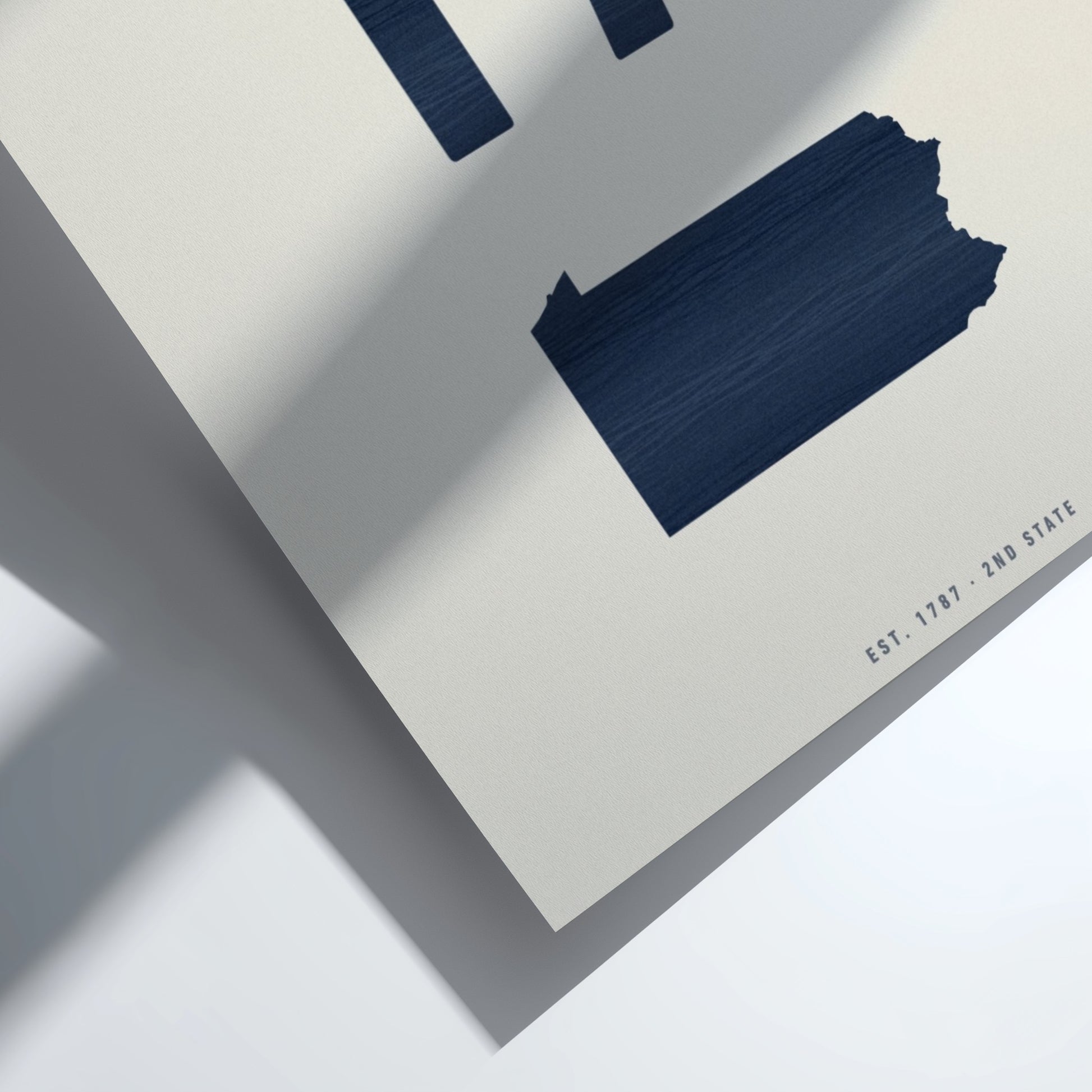 Navy blue paint swatch on a textured white surface 